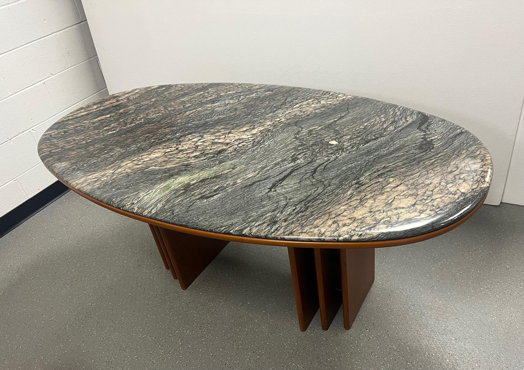 This is an oval Danish teak and marble top dining table, Seats 6 comfortably. Very nice condition. Minimal wear. Made by Bendixen. Label on the wood table top. The table has a wood table top base. The marble top sits on the wood base. 
Dimensons: