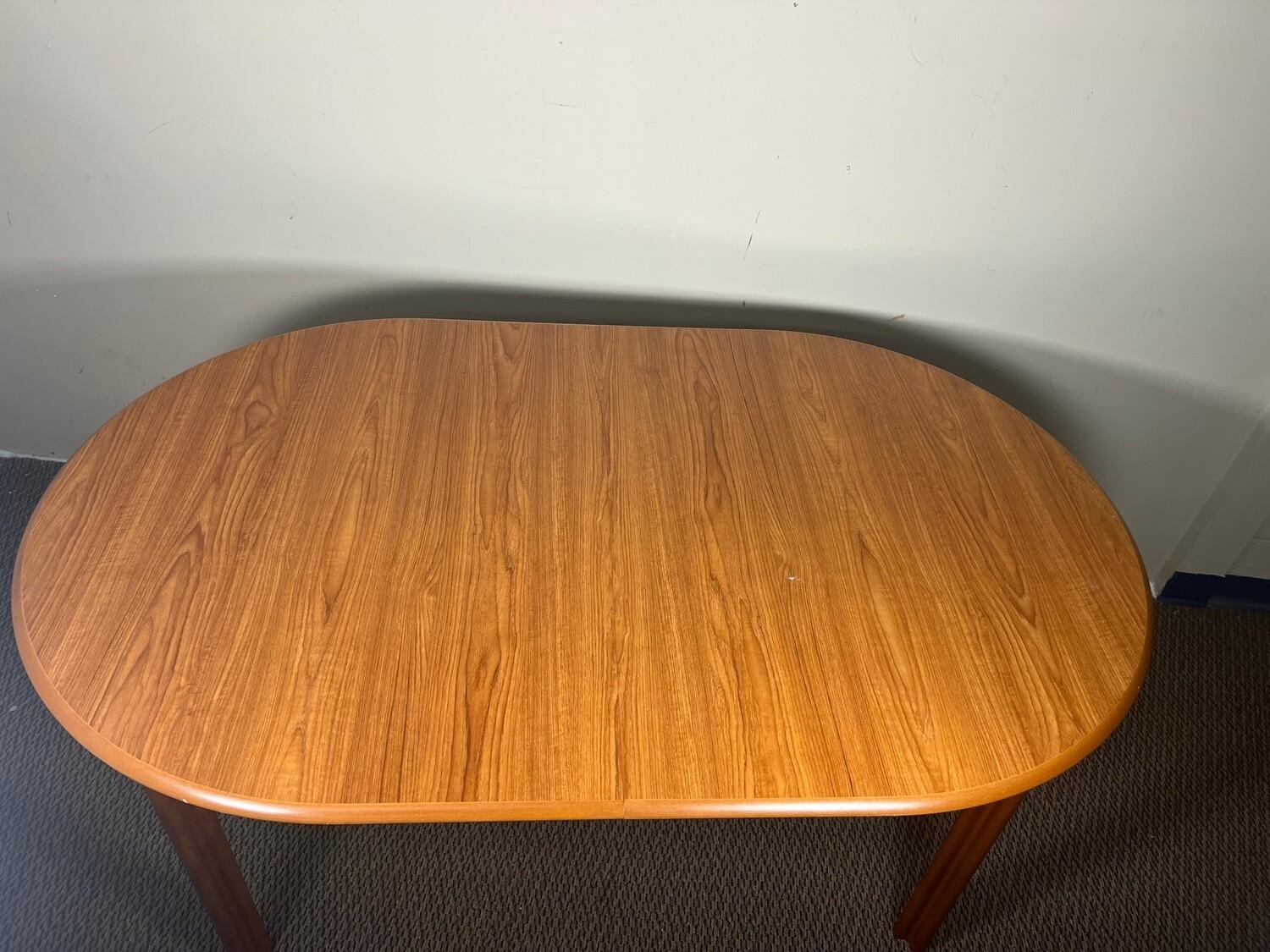 This is an oval  teak dining table with pop up leaf. Seats 6 - 8 people comfortably. The leaf is stored inside the table when not in use and can easily be opened up to incrrease the length of the table to 76