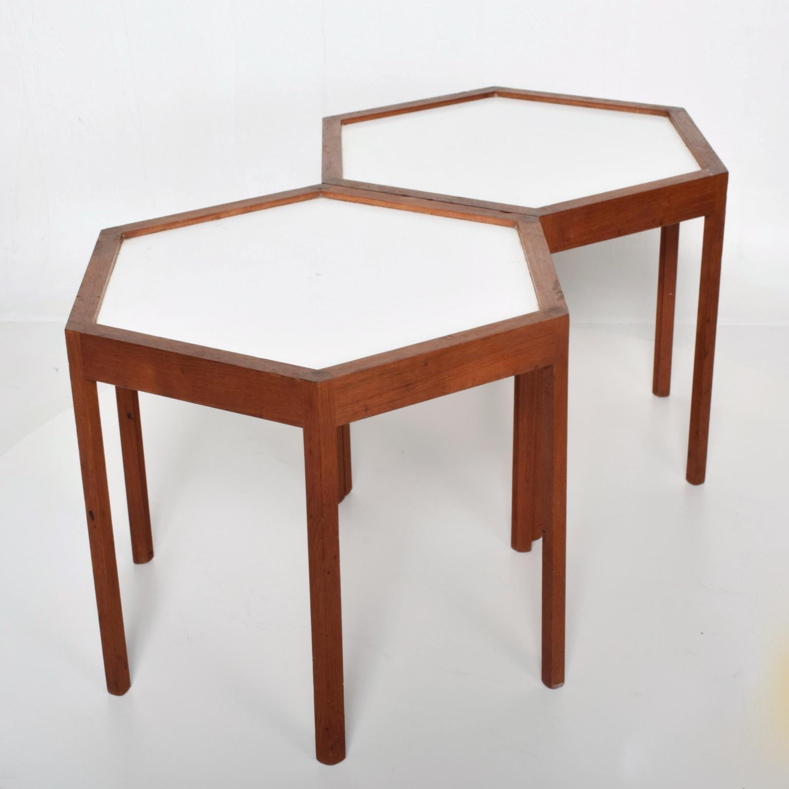 For your consideration, a pair of side tables by Has C. Andersen. Made in Denmark, circa 1960s. Hexagon shape with solid teak wood and white Formica top. Dimensions: 14 1/2