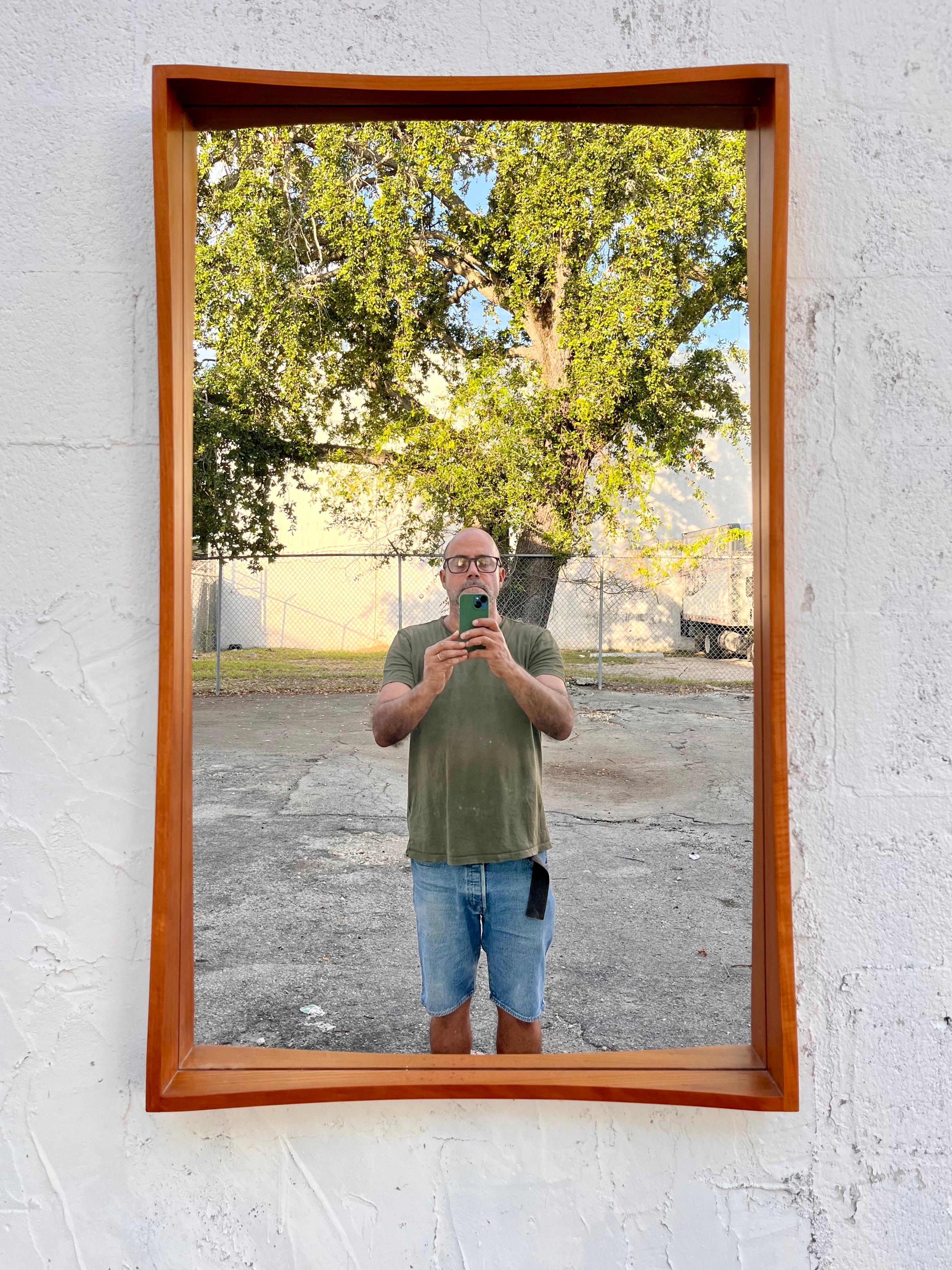 Large Vintage Mid Century Danish Modern Pedersen & Hansen entry wall mirror. Circa 1960s.
Features a Scandinavian Modern Minimalist design, a slender solid teak wood rectangle frame, and finger jointed corners. 
A slender entry mirror with a thin