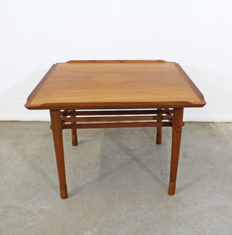 Offered is a vintage Danish modern style teak side accent table. This is a custom made piece with a sculptural top and slats underneath, similar to the style of Poul Jensen. It is in good, stabile condition with minor sun fade on the top and minor