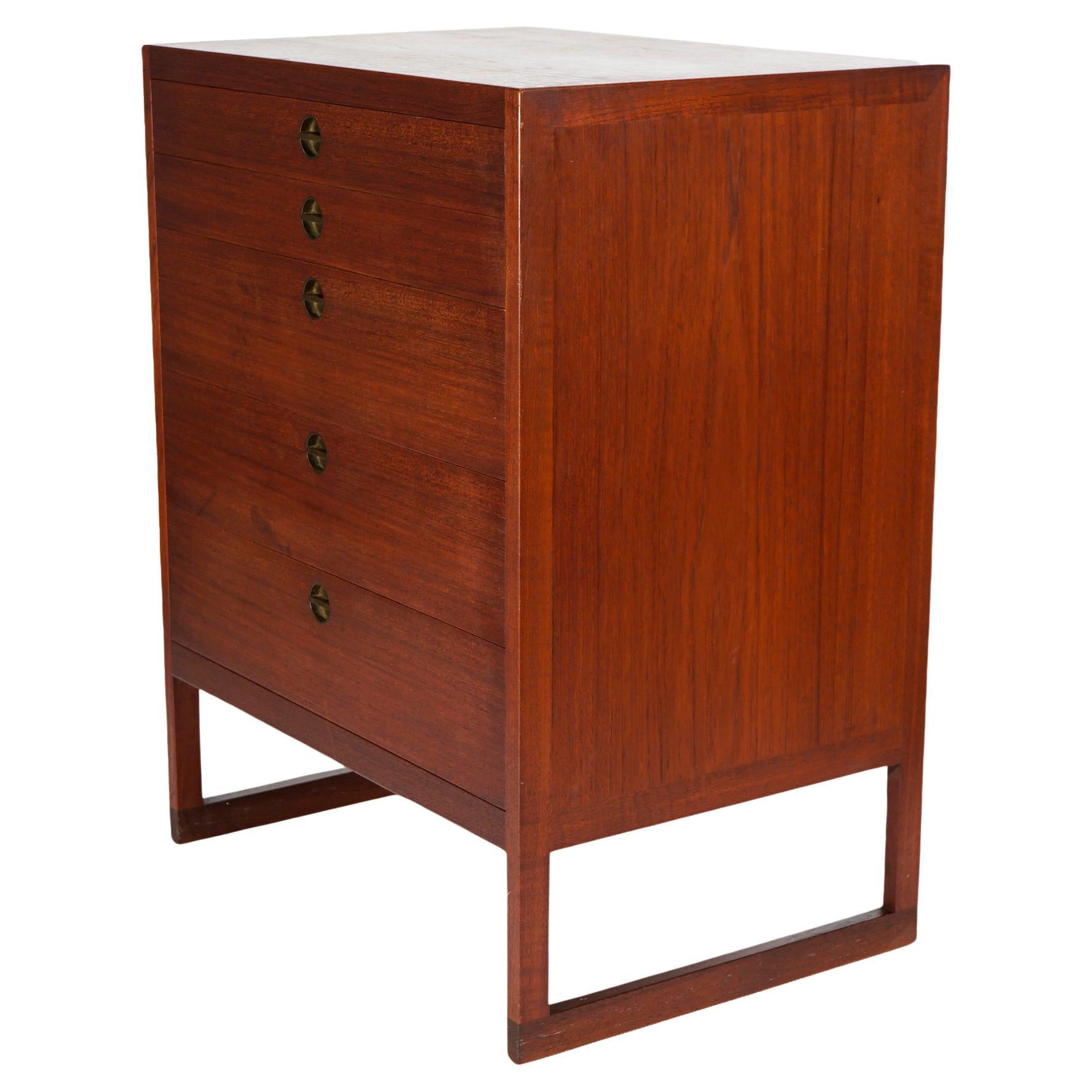 A Mid Century Danish Modern chest of drawers by cabinetmaker Povl Dinesen of Copenhagen, Denmark offers teak wood construction with two shallow drawers over three deeper drawers, all with brass pulls, maker label as photographed, c1960

Measures -