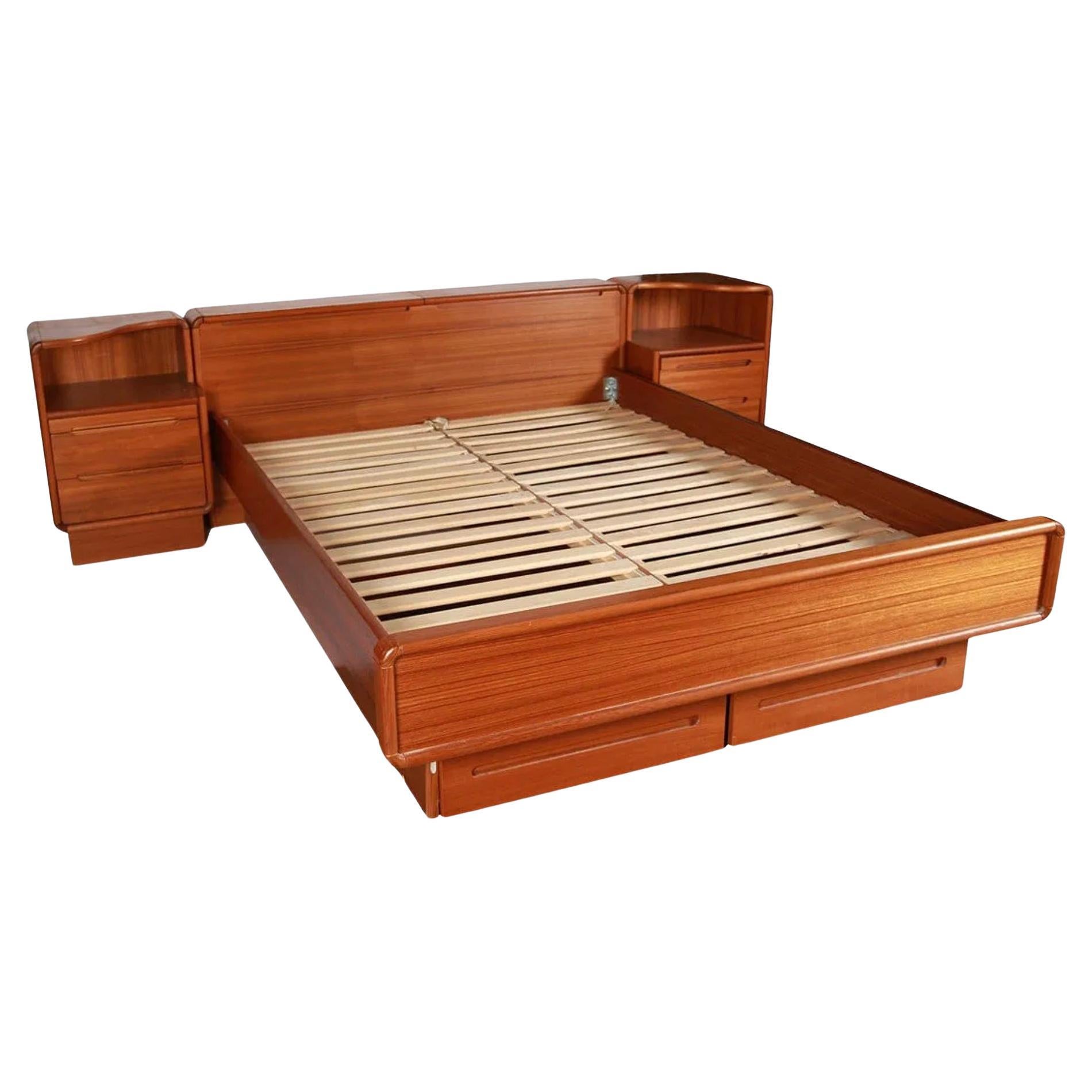 Stunning Mid century Danish Modern Teak Platform Queen Size Bed with Nightstands flip up headboard storage and 2 lower storage drawers. Beautiful Platform bed that sits on a platform base. It has (2) top teak flip up doors in the headboard for