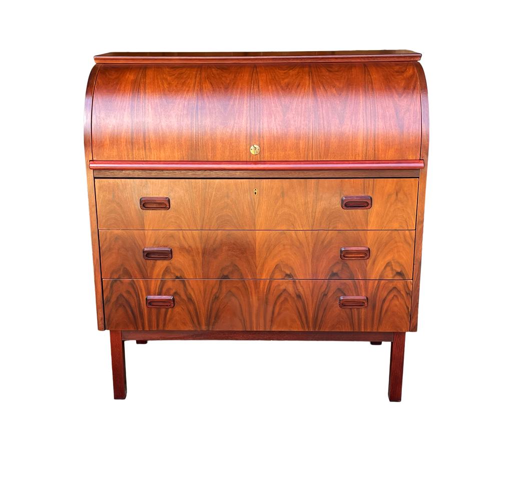 A writing desk and cabinet from Denmark circa 1960's. It features beautifully grained rosewood with tons of storage. Writing table extends outwards which isn't shown in photos. Comes with original key.