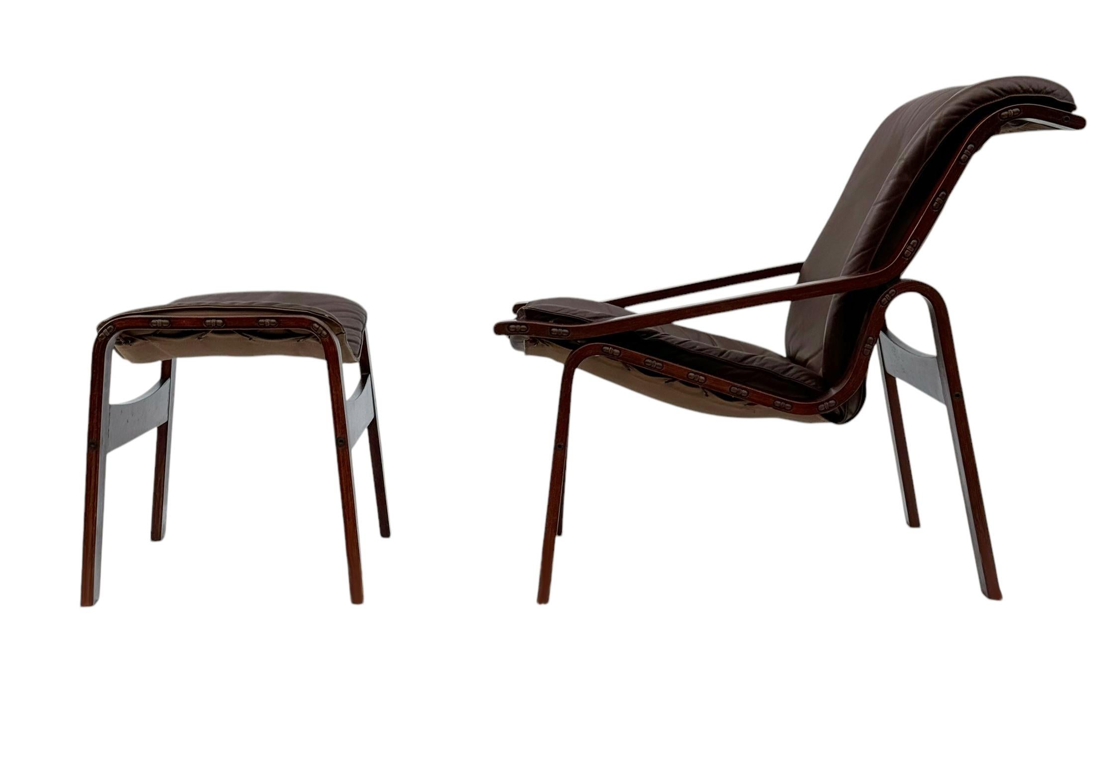 Norwegian made designer lounge chair & ottoman set circa 1972.  It features rosewood stained solid wood chair frames with chocolate brown leather upholstery.  Price includes the set as shown. 