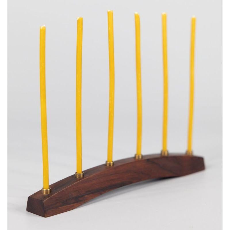 A lovely mid-century Danish modern rosewood candelabra with six brass candle holders made in Denmark, circa 1960. Marked 