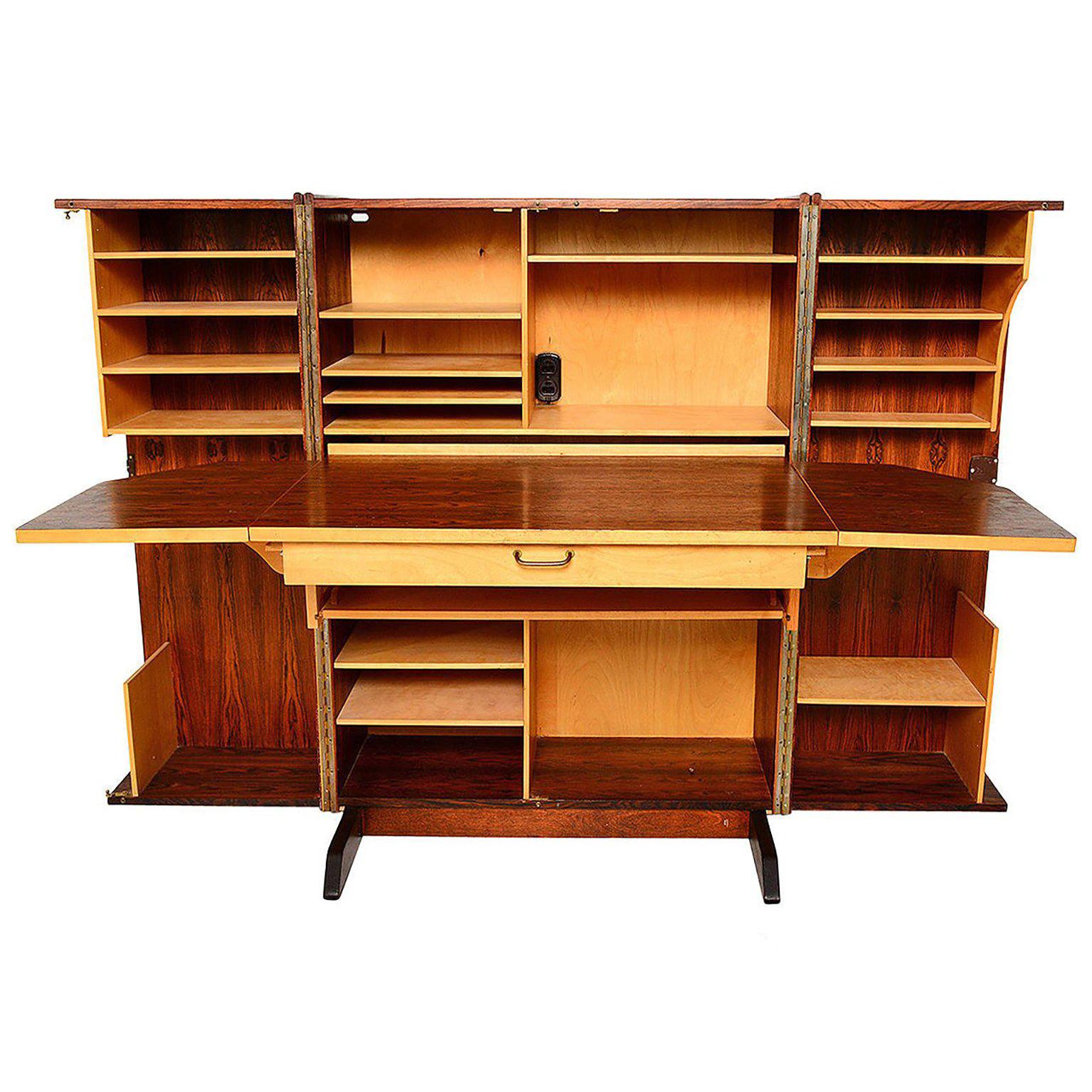 For your consideration a very rare and hard to find hideaway desk in exotic rosewood.

When the desk is closed it show a nice cabinet beautifully finished with exotic rosewood. Once you open the desk, the pull-out area showcase a large writing area