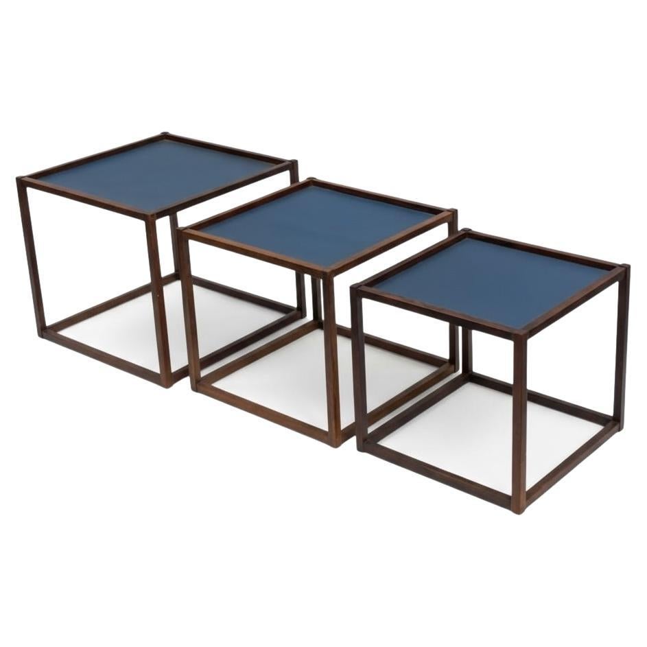 This is a set of three mid-century Danish modern nesting / stacking tables designed by Bodil Kjaer for Pedersen & Son. The rosewood frames have clean lines, and the faux leather tops are in good condition. They date to the 1950s.