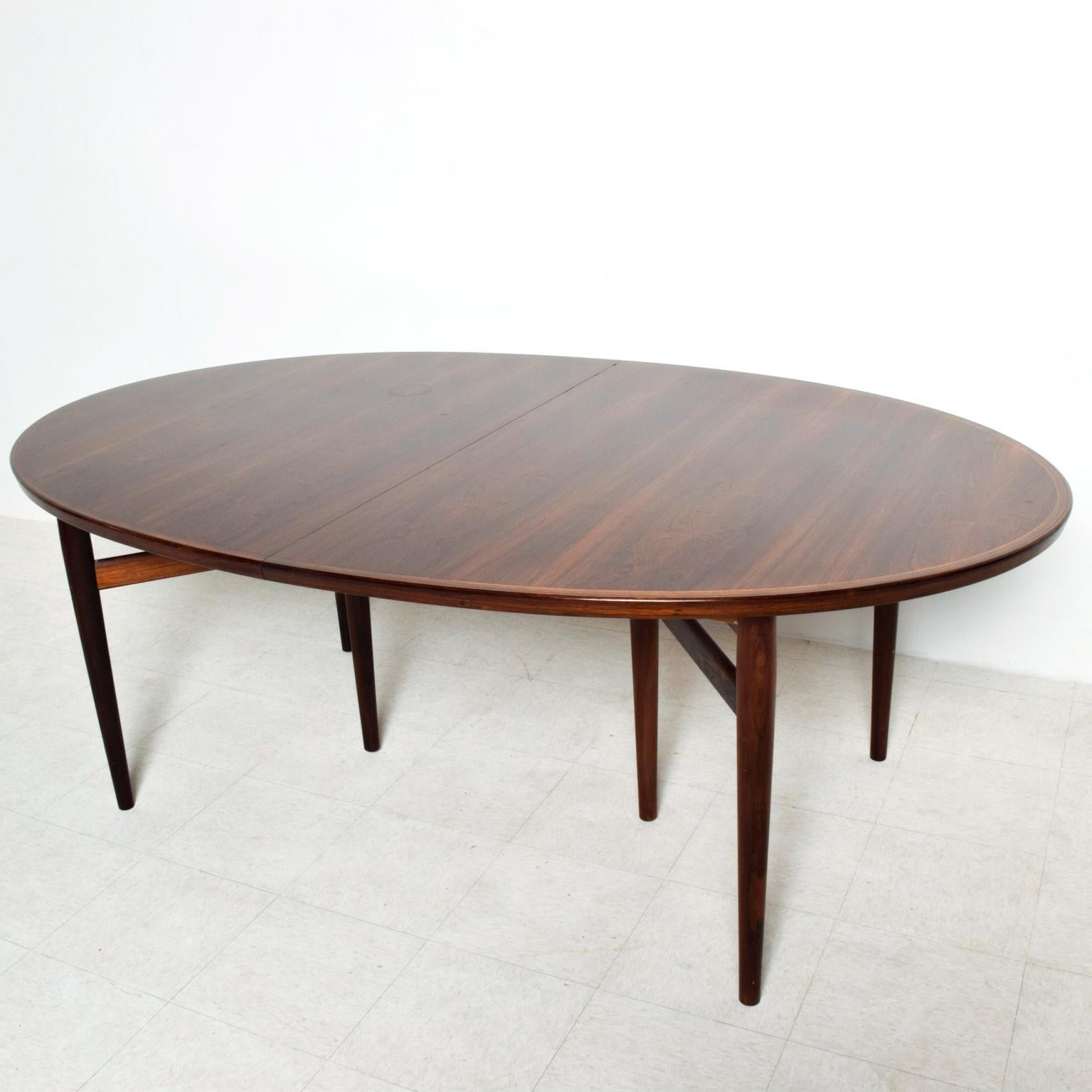 We are pleased to offer for your consideration a beautiful rosewood dining table with an oval shape. Designed by Arne Vodder for SIBAST. Denmark circa 1960s. We have the matching dining chairs, set of six in another posting (solid rosewood with faux