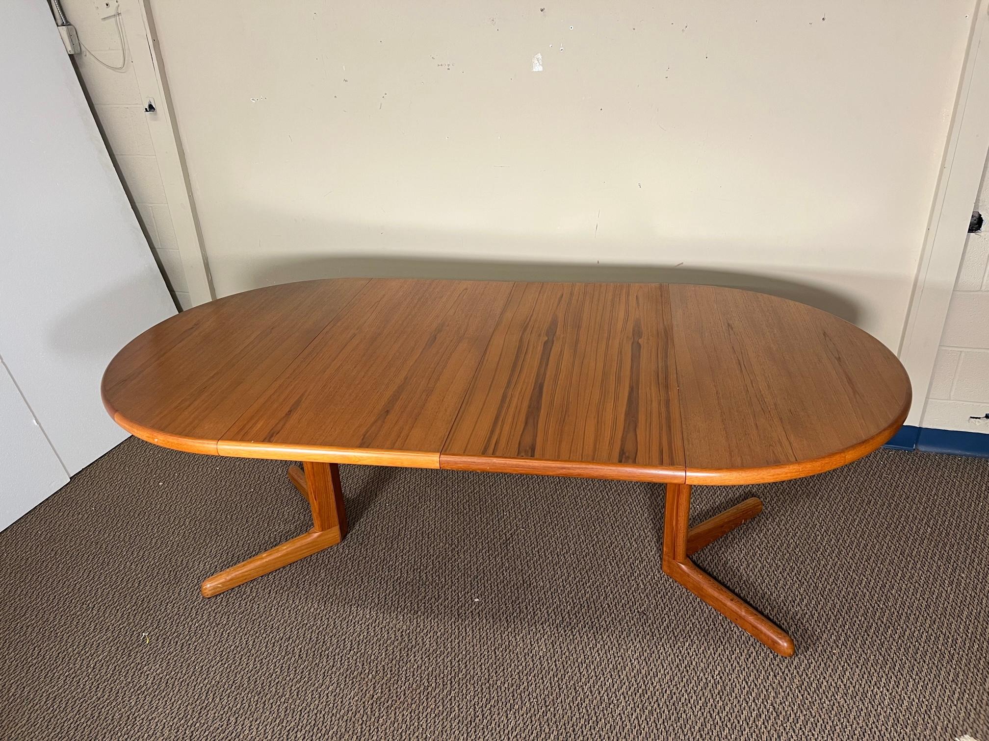 This is a round Danish teak dining table with 2 extension leaves. Seats 8 comfortably. Table only. Chairs and painting sold separately. 
Very nice condition. Veneer coming loose a little on one leaf. Slight color difference on leaves. 
Dimensions: