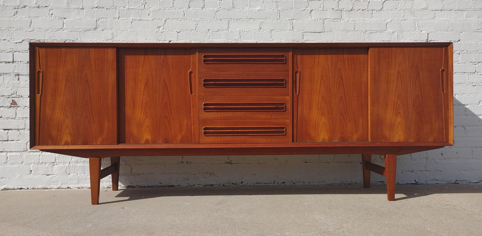 Mid Century Danish Modern Sideboard by Jensen & Molholm

Above average vintage condition and structurally sound. Has some expected slight finish wear and scratching. Top has been refinished and does not have original factory finish. Outdoor listing