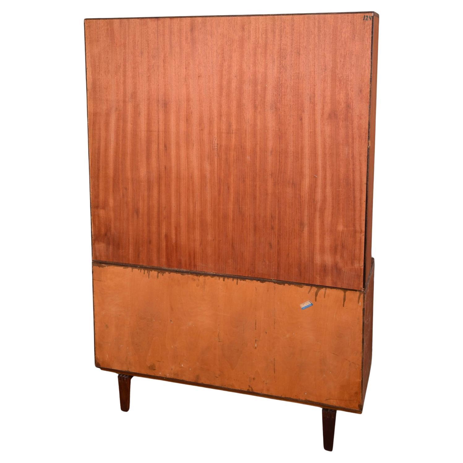 Beautiful mid century Danish modern credenza with shelf unit designed by Peter Løvig Nielsen for Dansk. Teak upper shelf cubby bookcase unit with shelves on top of lower teak credenza has two cabinet doors with adjustable shelves and brass hardware.