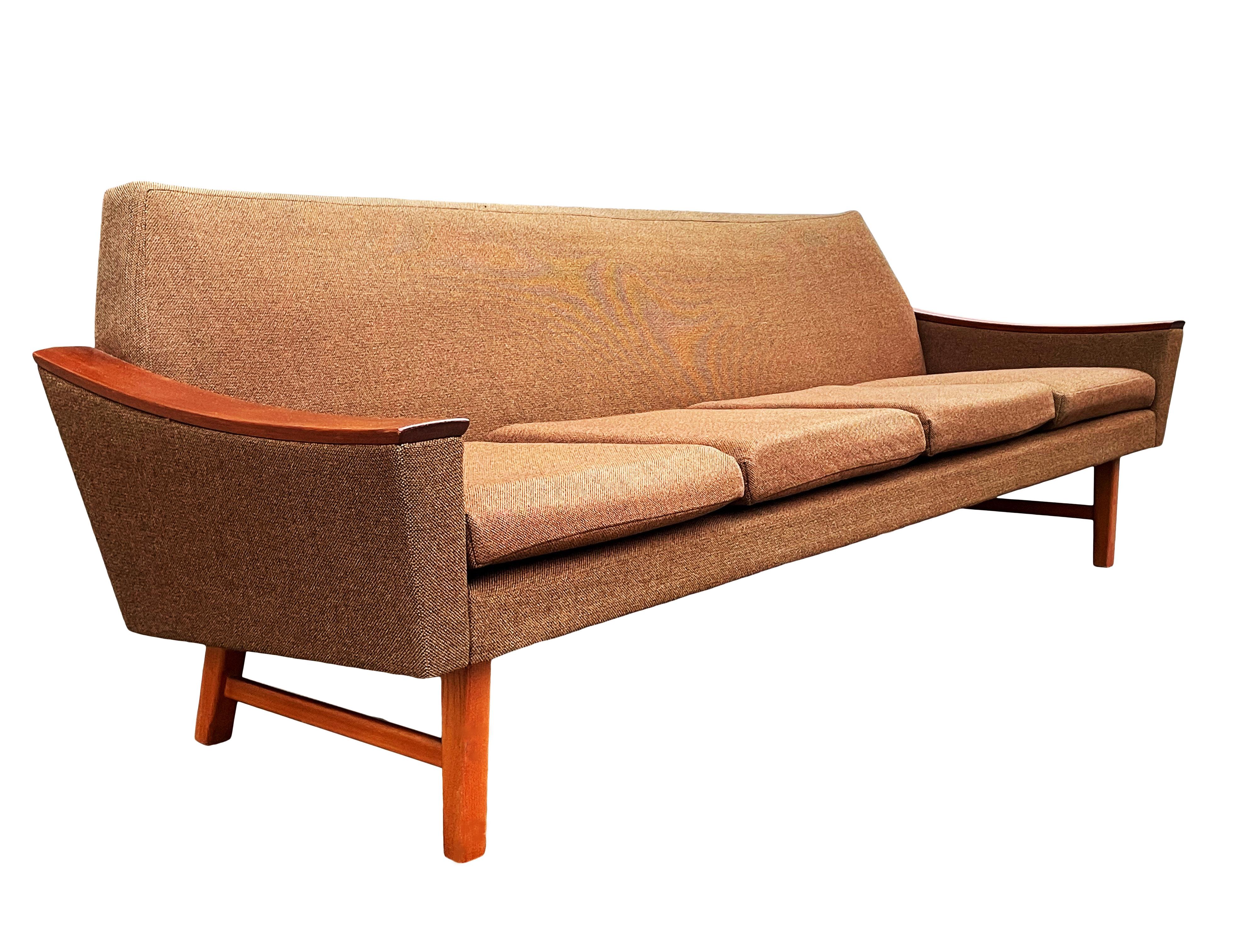 A sleek modern sofa designed by Oscar Langlo and produced in Norway, circa 1960. This sofa is all original with teak wood details and original brown tweed upholstery. Manufacturer label. In original and ready to use condition.