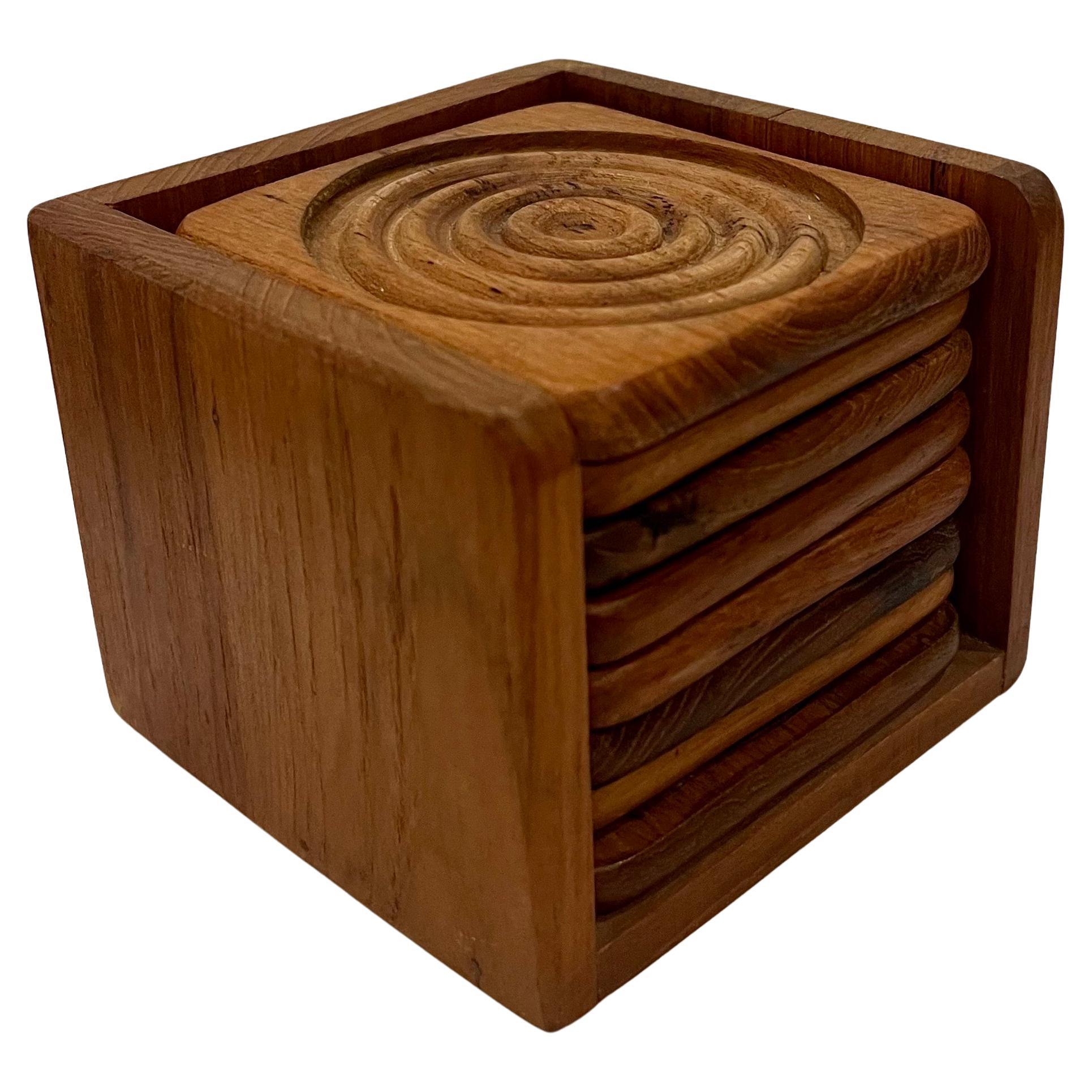 Mid-Century Danish Modern teak coaster set with caddy in the style of Dansk. Concave design. Includes 8 

Each coaster is 4