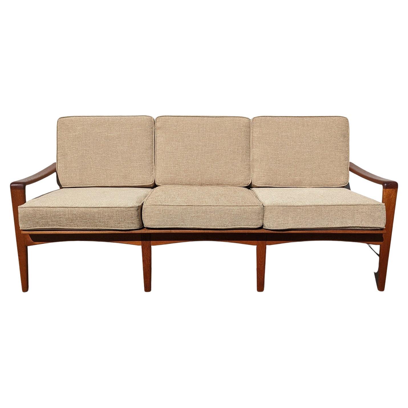 Mid Century Danish Modern Solid Teak Sofa by Arne Wahl Iversen

Above average vintage condition and structurally sound. Has some expected slight finish wear and scratching on frame. Upholstery is new. Outdoor listing pictures might appear slightly