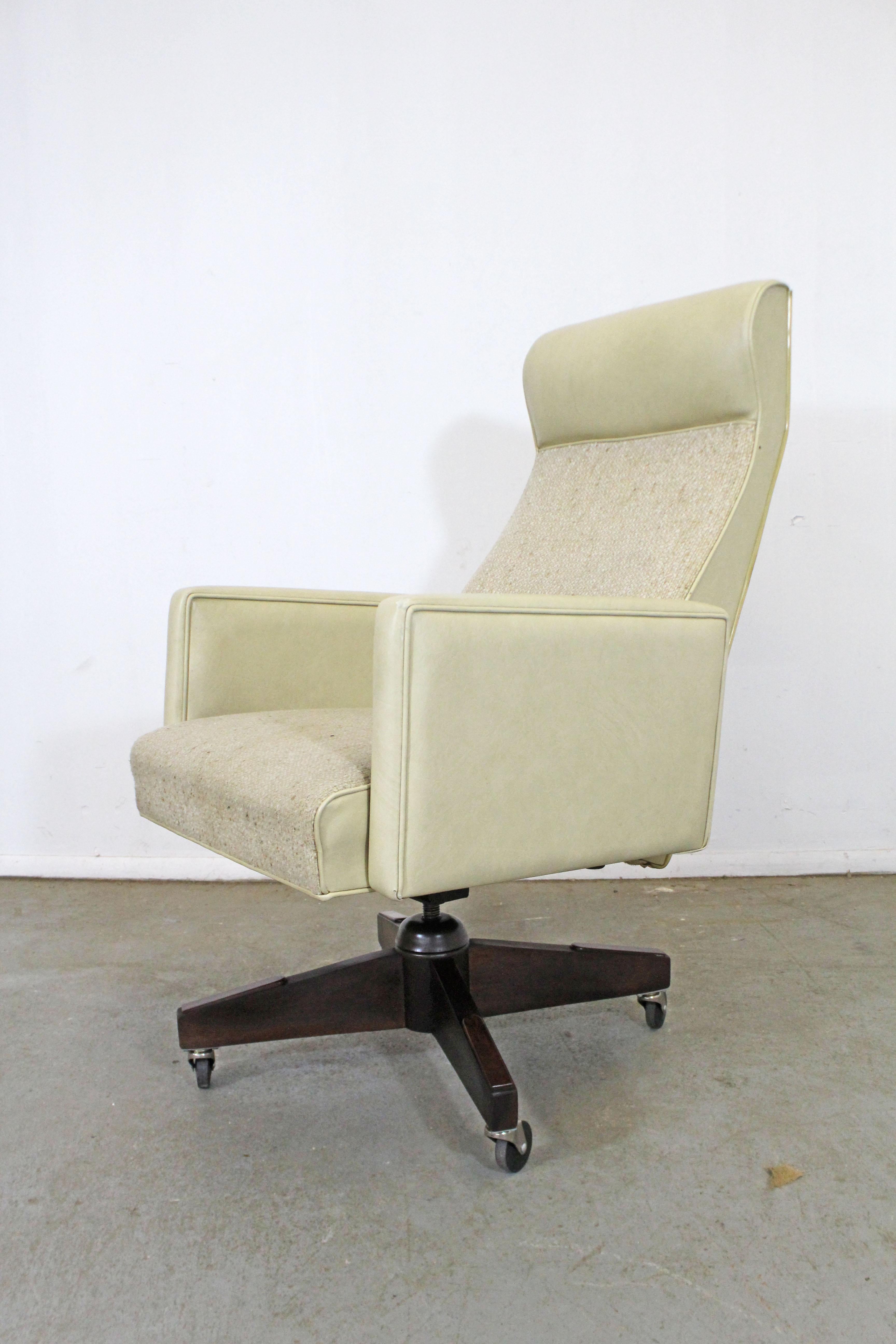 What a find. Offered is a vintage Mid-Century Modern office chair. This chair swivels, reclines, and is extremely comfortable. Has vinyl upholstery and a wooden base. It's in decent condition for its age, but has some minor tears and age wear (see