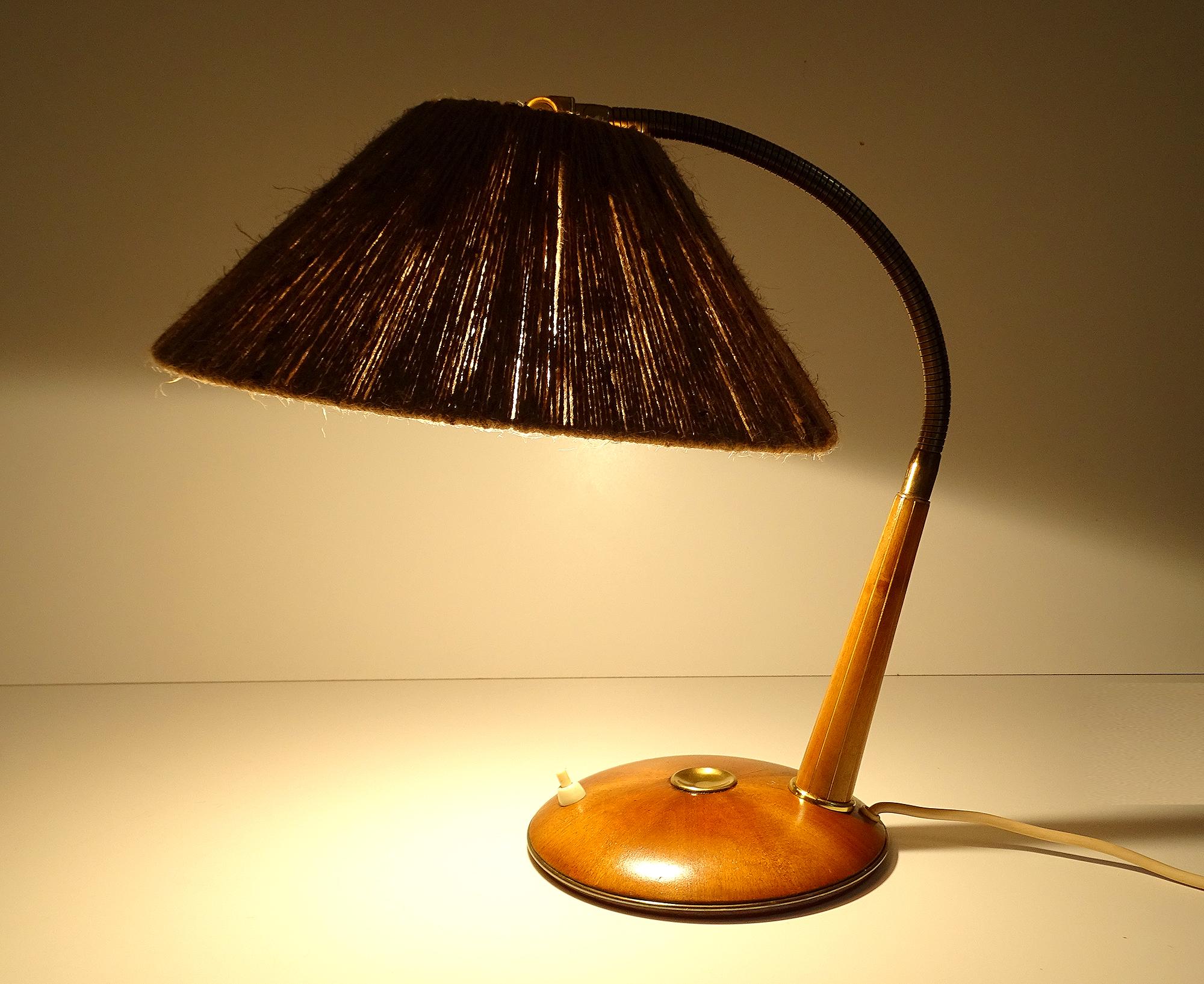 Midcentury Danish modern  table or desk lamp manufactured by the swiss-german Temde Manufacture, this is the model nr 31, featuring a base with a star shape marquetry of wood veener with a central knoby brass button, the first section of the stem