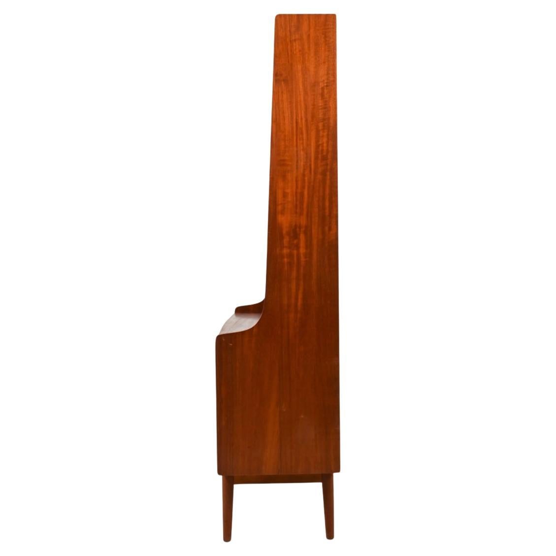 Mid Century Danish Modern Tall Teak bookcase with lower credenza By Designer Johannes Sorth. This tall bookcase has 4 back shelves and 1 Adjustable shelf inside the lower sliding door credenza. C. 1960 With model No. 335-113 on back panel and 1967