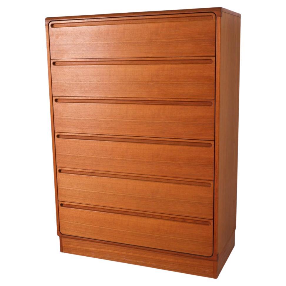 Mid century danish modern tall teak dresser by Nils Johnson. Beautiful tall 6 drawer teak dresser with high quality woodworking. Curved drawer fronts with inset handles. Labeled -  Designed by Nils Johnsson made by Torring Mobler. Made in Denmark.
