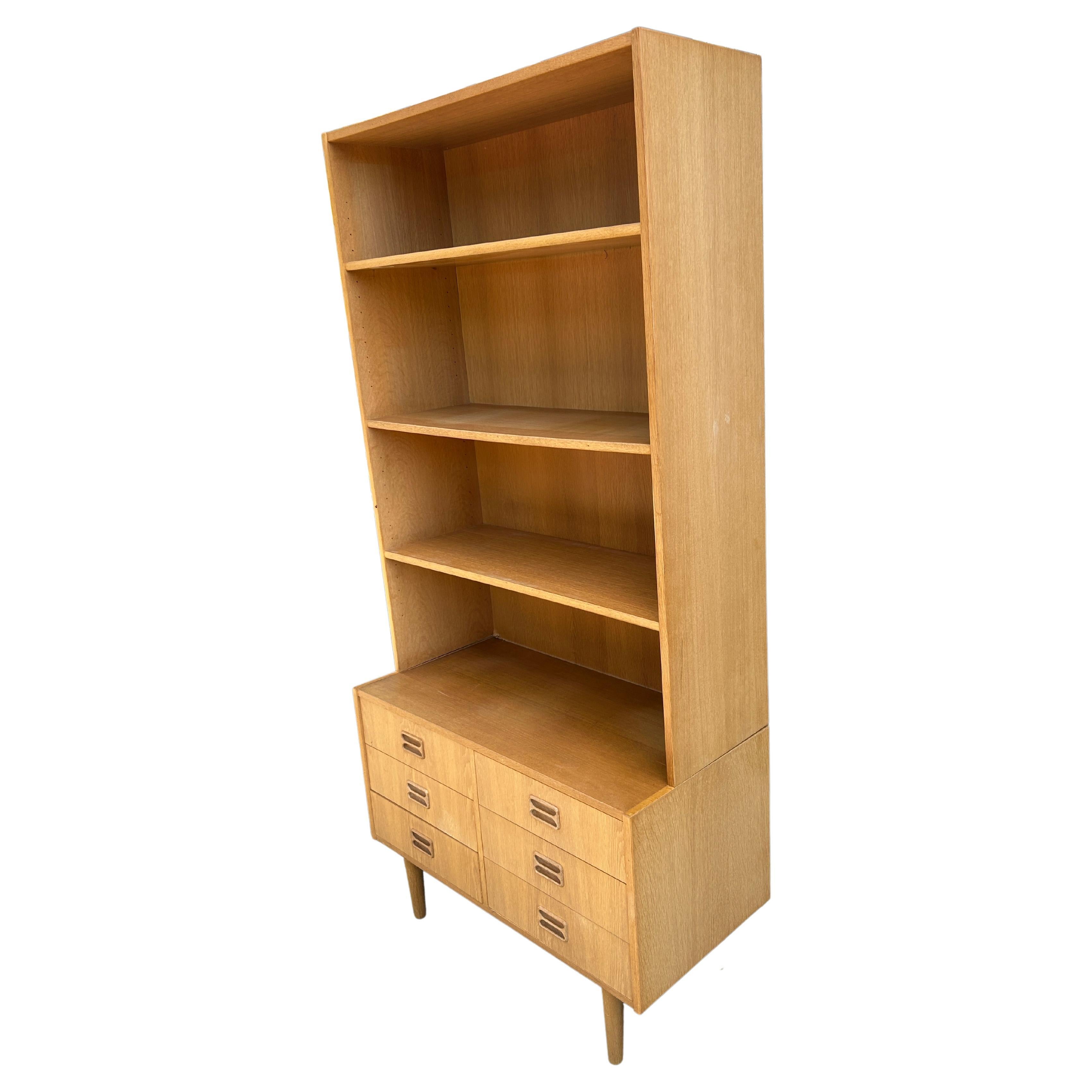 Midcentury danish modern tall light white oak bookcase with lower 6 drawer dresser. Great tall narrow Wall unit bookcase with Lower dresser. Lower small 6 drawer dresser on tapered oak legs with carved Handles. The top has 3 Shelves with 2 of them