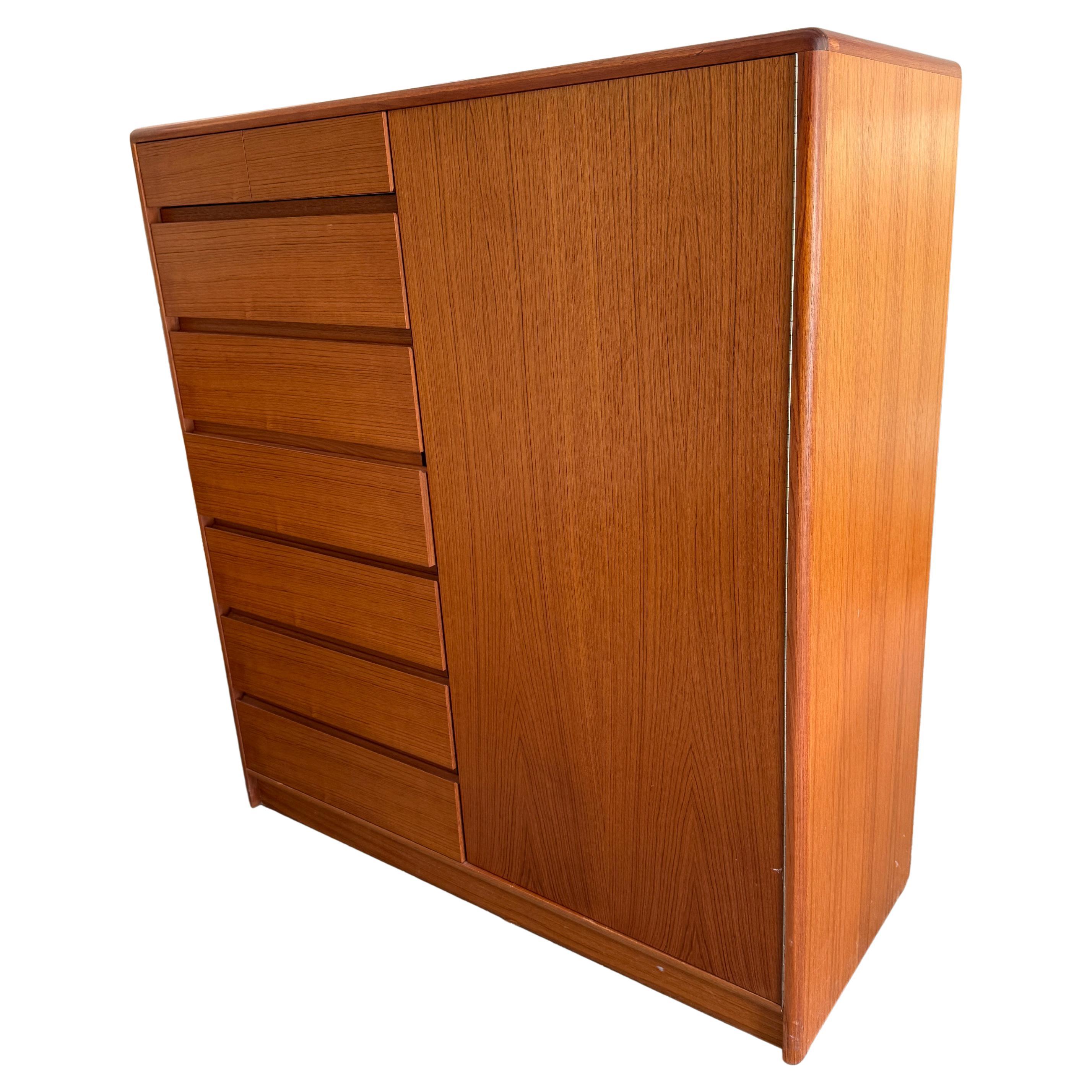 Mid century Danish Modern tall teak dresser credenza 8-drawers on left that is labeled Nordisk Andels-Eksport - Made in Denmark. Good vintage condition. Has right cabinet door with 3 drawers and 2 Adjustable shelves with Pins. Very clean Wardrobe