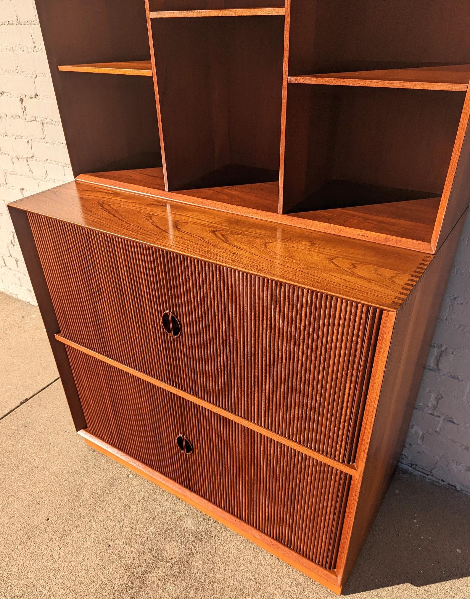 Mid Century Danish Modern Tambour Door Cabinet by Hvidt & Molgaard

Above average vintage condition and structurally sound. Has some expected slight finish wear and scratching. Has a couple small dings on edges and top has a split in wood where the