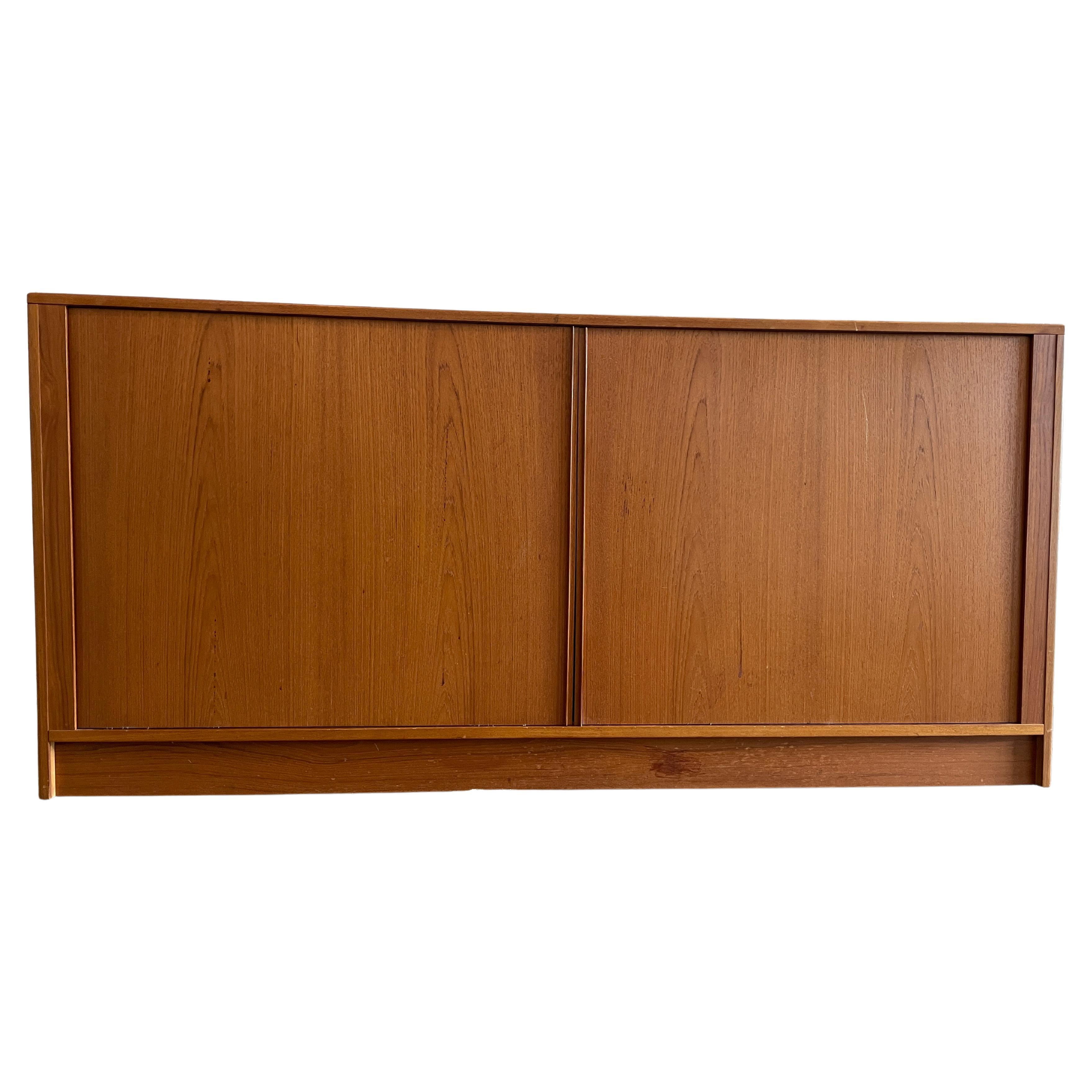 Mid-century Danish modern Tambour door credenza dresser with 12 drawer. Light teak credenza or dresser with front sliding tambour doors behind the doors are 12 teak drawers with 2 adjustable shelves. All drawers are clean and slide smooth. Made in