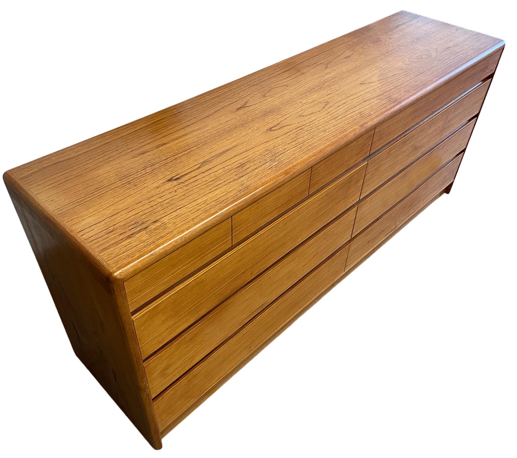 Beautiful mid-century Danish modern teak 10 drawer dresser Credenza by Nordisk Andels-Eksport. Great simple design and great vintage condition - clean inside and out. Drawers slide smooth with dovetail construction. Has 3 small top drawers on left