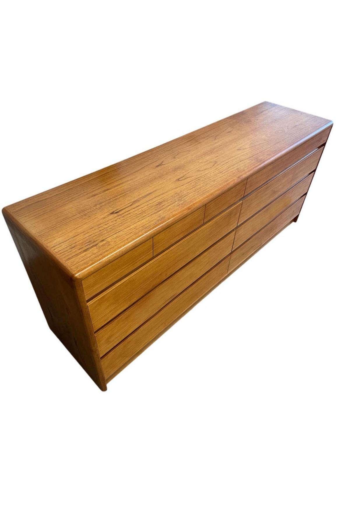 Beautiful mid-century Danish modern teak 10 drawer dresser Credenza by Nordisk Andels-Eksport. Great simple design and great vintage condition - clean inside and out. Drawers slide smooth with dovetail construction. Has 3 small top drawers on left
