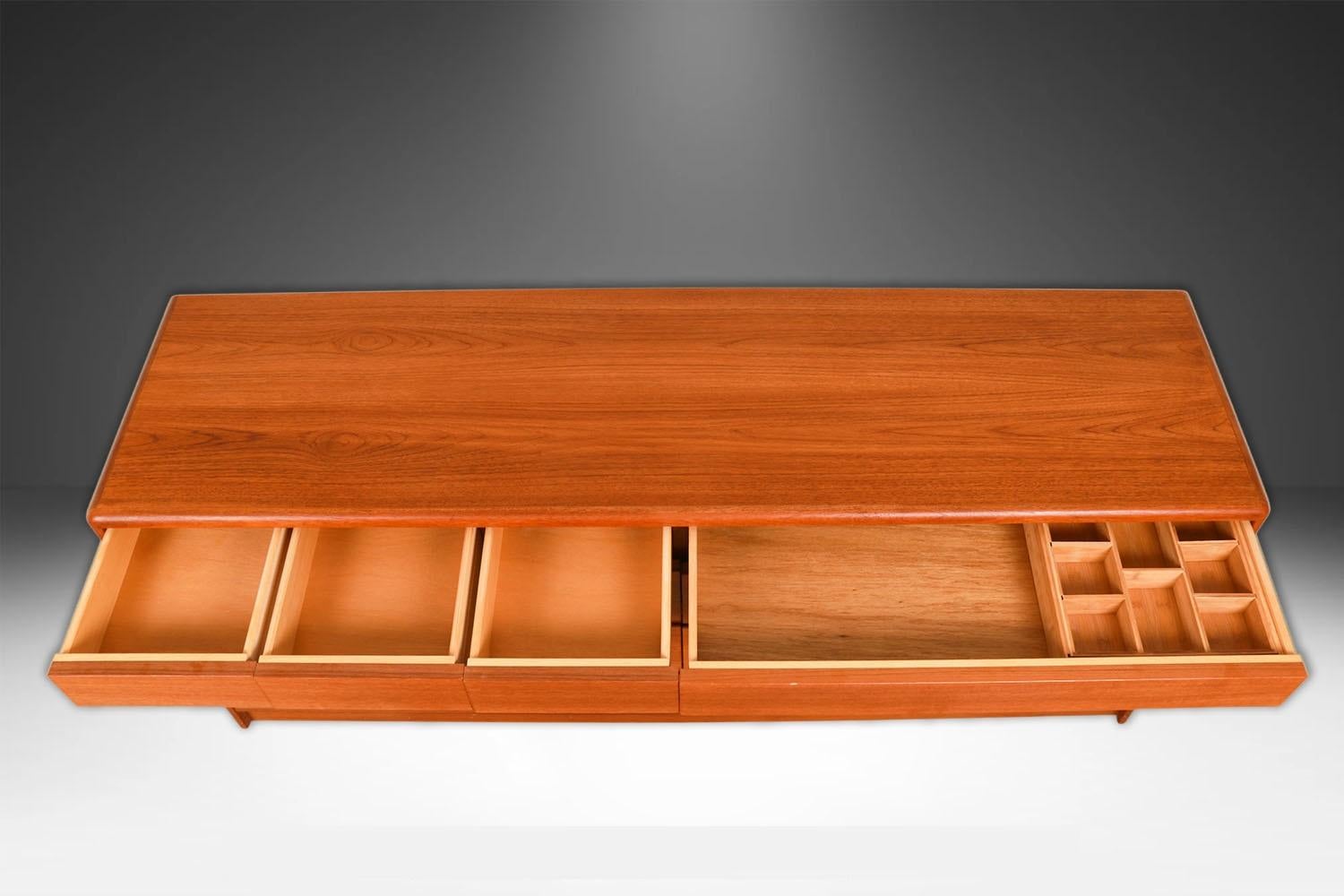 Attractive long, low, Danish modern, sleek, smooth face, teak 10 drawer dresser. A minimalistic teak double dresser by Nordisk Andels-Eksport made in Denmark.  This is a very simple yet modern 10 drawer design, the craftsmanship is quite striking,