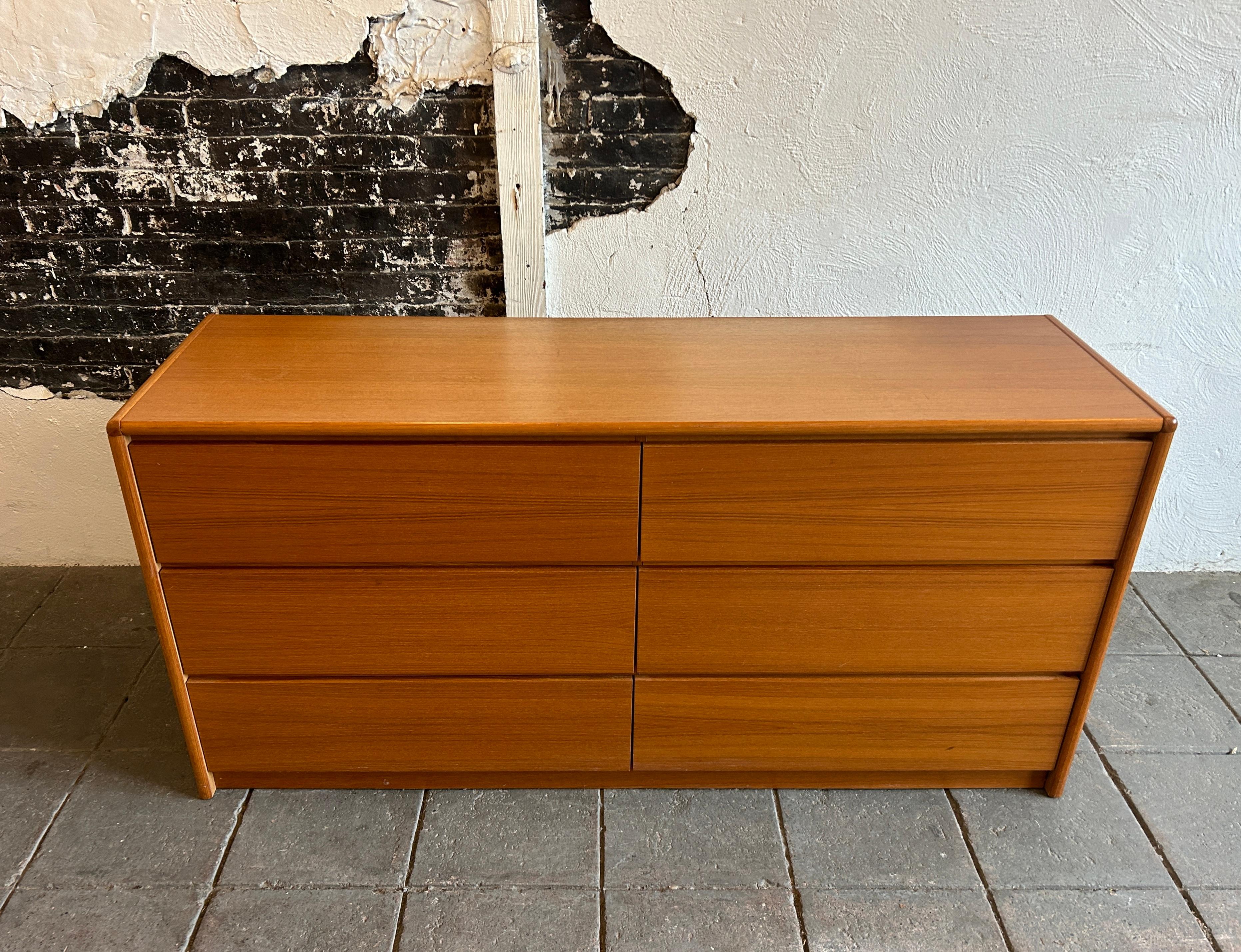 Mid century Danish modern Teak 6 drawer dresser. Clean simple Danish modern dresser with 6 drawers clean inside and out. Has carved lower handle pulls under drawer face. Really beautiful medium brown teak wood with very nice grain. Made in Denmark.