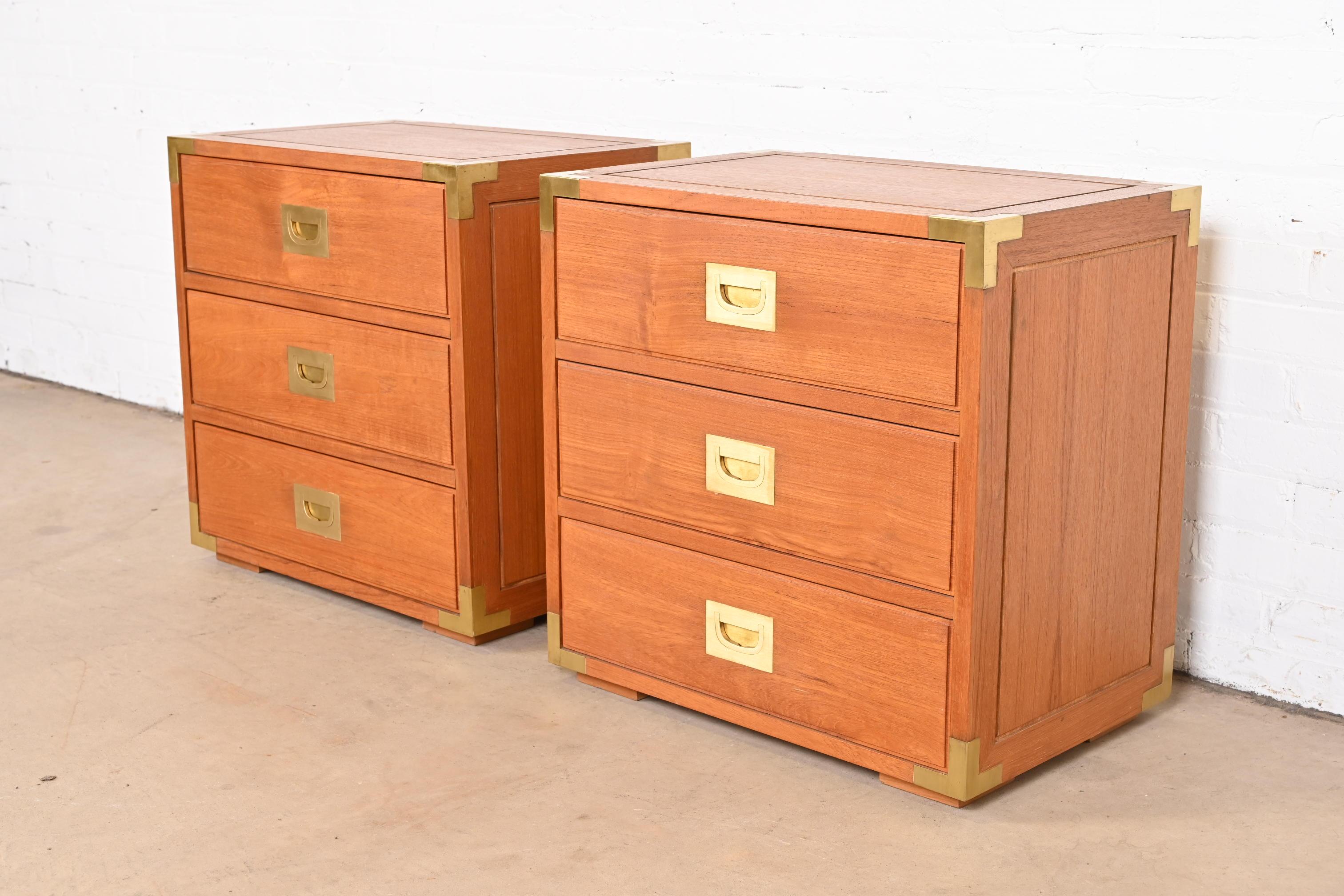 A gorgeous pair of midcentury Danish Modern two-drawer Campaign style nightstands or bedside chests

Denmark, circa 1970s

Teak, with original brass hardware.

Measures: 24