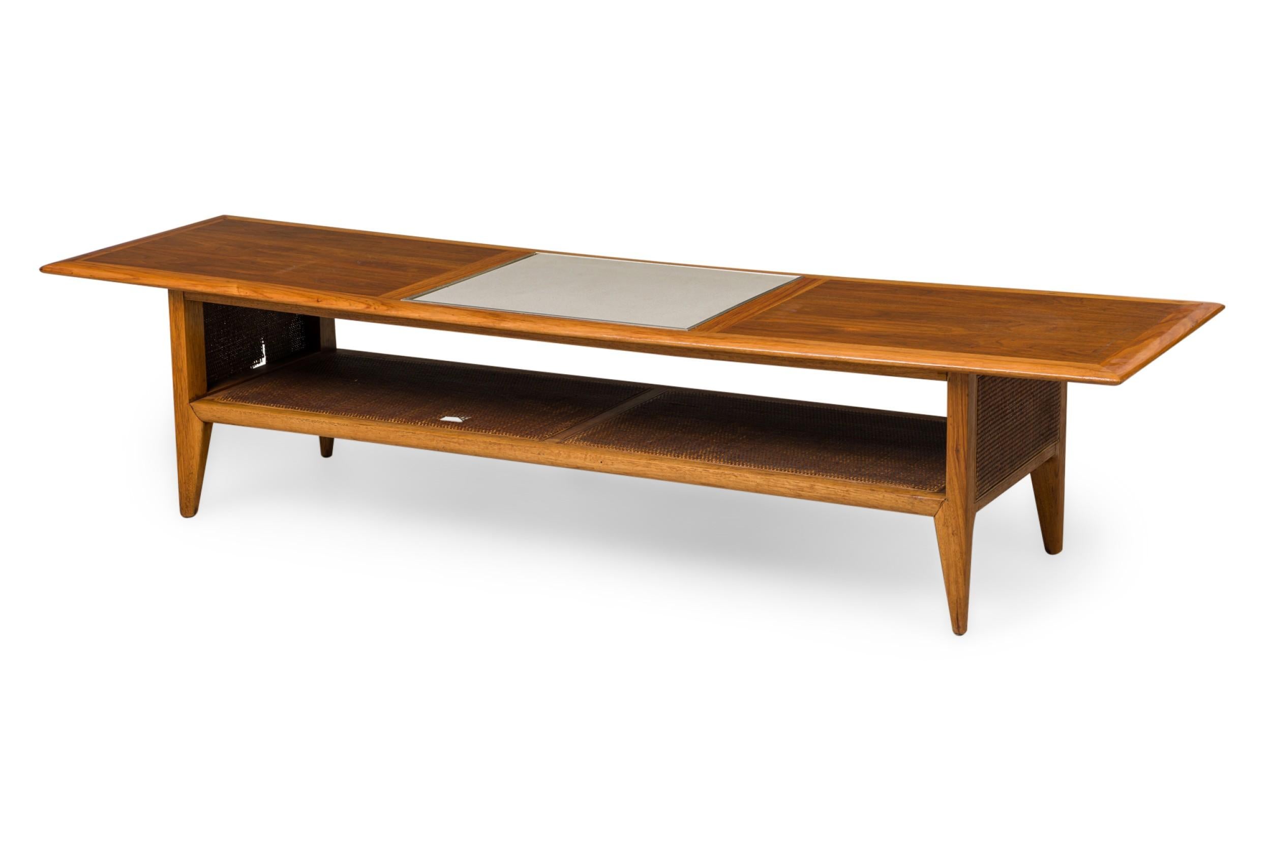 Mid-Century Danish Modern rectangular low coffee table with a lower tier caned shelf plus sides, standing on 4 tapered legs. (In the style of HANS WEGNER)

Caning losses.
