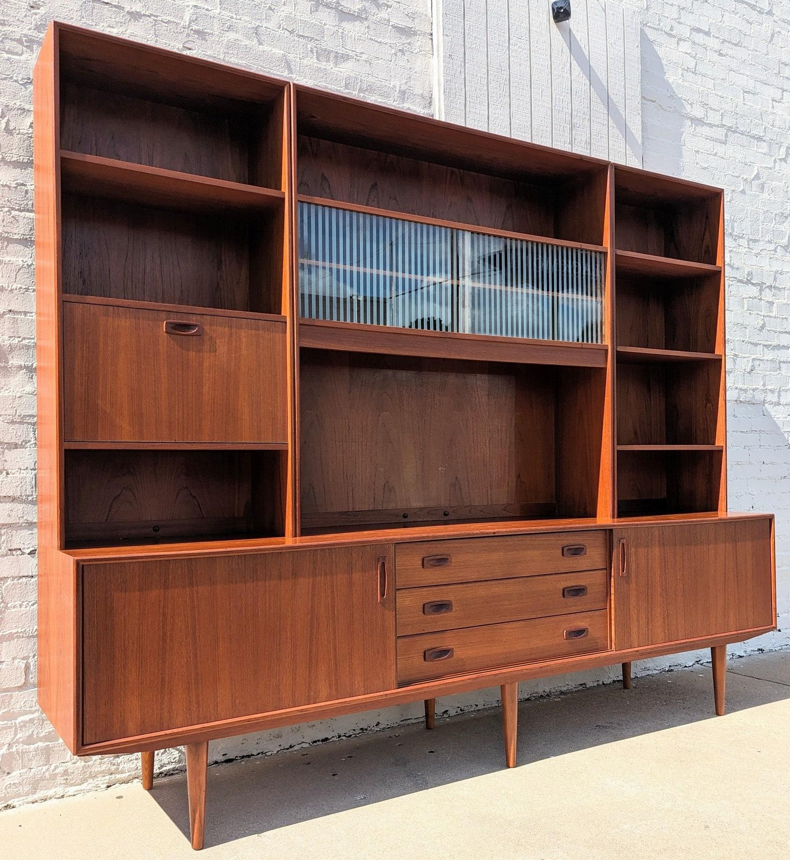 Mid Century Danish Modern Teak Bookcase Cabinet

Above average vintage condition and structurally sound. Stellar, unique piece. Has some expected slight finish wear and scratching. Has a couple small dings and discolorations on top. Glass has some