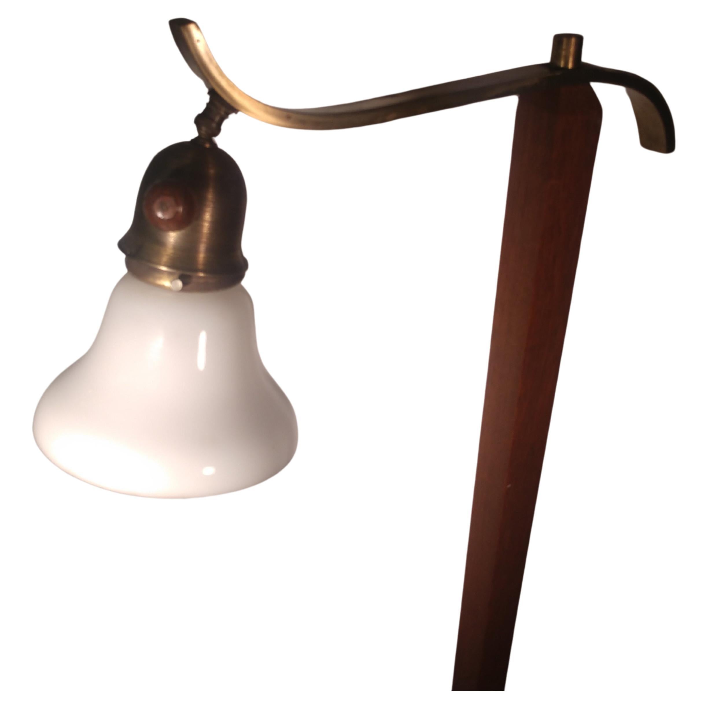 Scandinavian Modern teak with brass reading floor with milk glass shade. Shade is adjustable. In excellent vintage condition with minimal wear. 