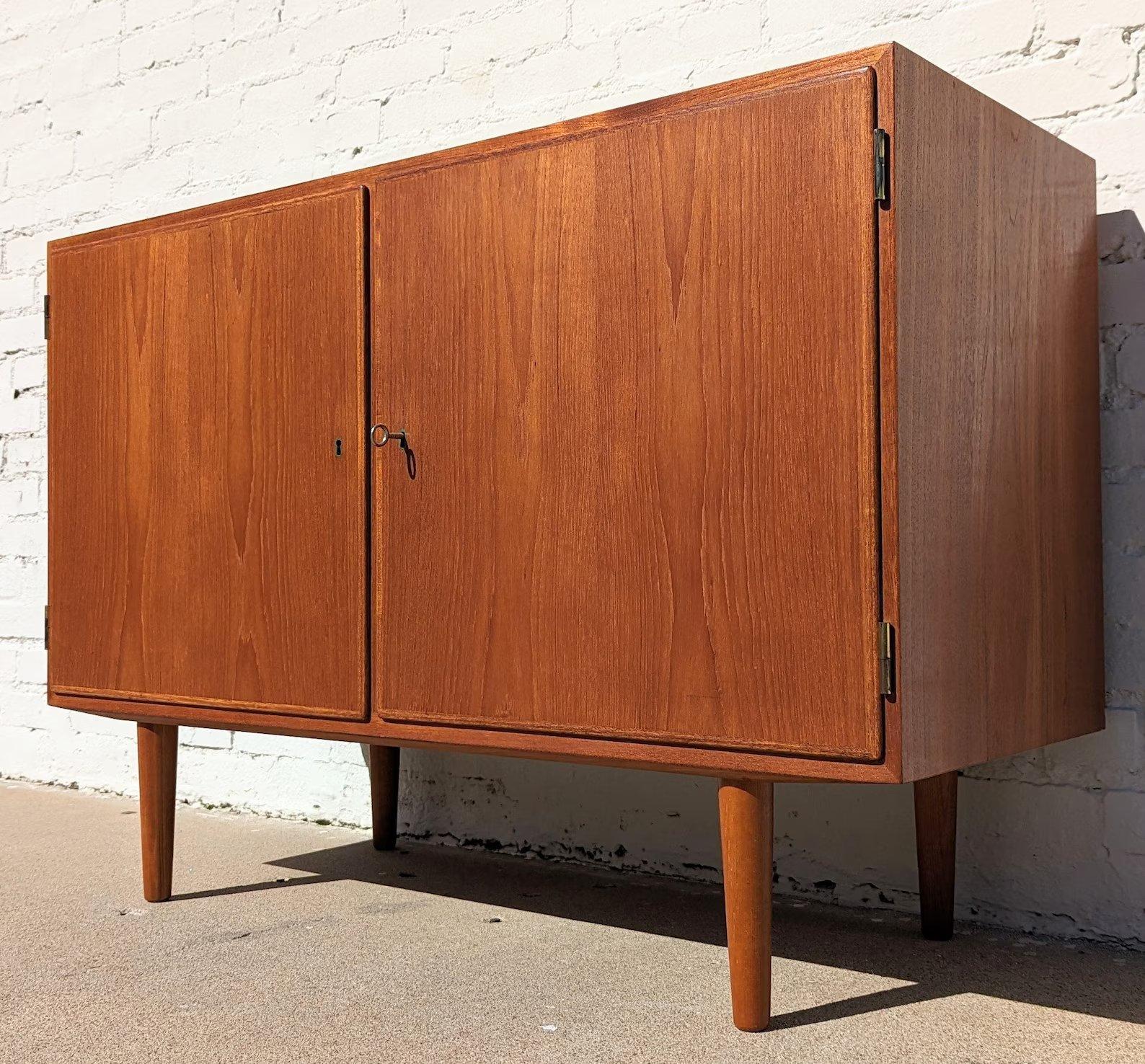 Mid Century Danish Modern Teak Cabinet

Above average vintage condition and structurally sound. Has some expected slight finish wear and scratching. Has a couple small dings on top. Top has been refinished. Outdoor listing pictures might appear