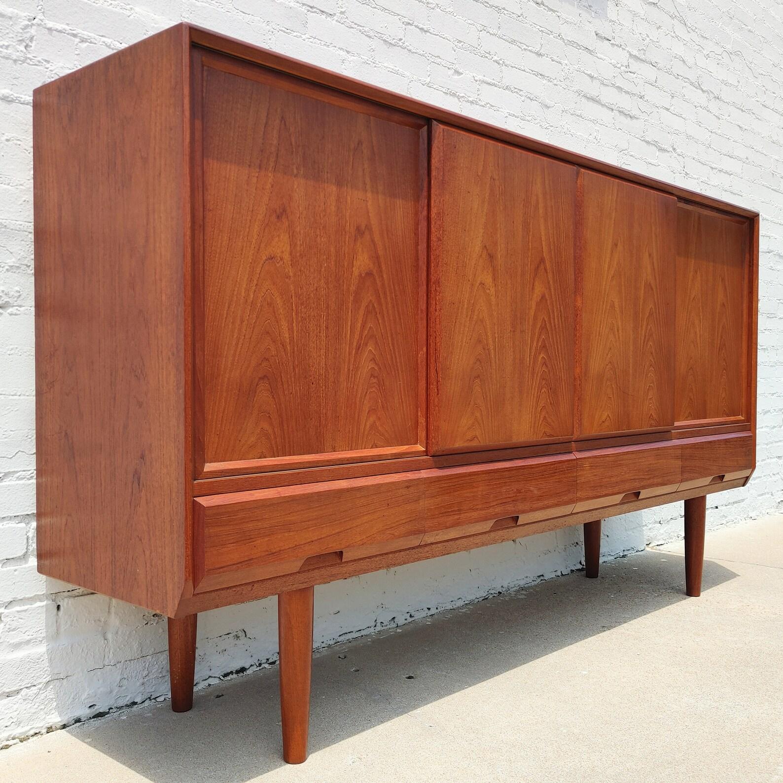 Mid Century Danish Modern Teak Cabinet
 
Above average vintage condition and structurally sound. Has some expected slight finish wear and scratching. Beautifully crafted with heavy construction. Has some discolorations on top with a couple
