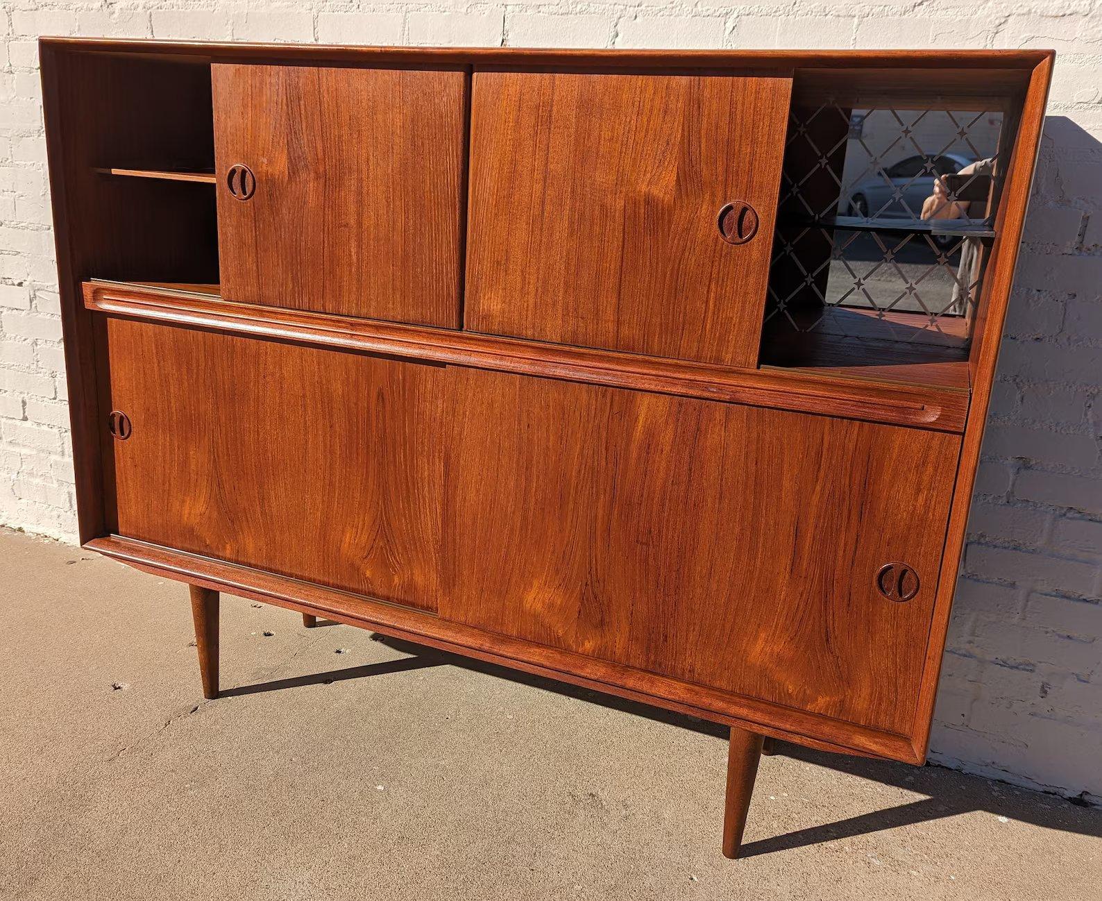 Mid Century Danish Modern Teak Cocktail Cabinet

Above average vintage condition and structurally sound. Has some expected slight finish wear and scratching. Has a couple small edge dings. Outdoor listing pictures might appear slightly darker or