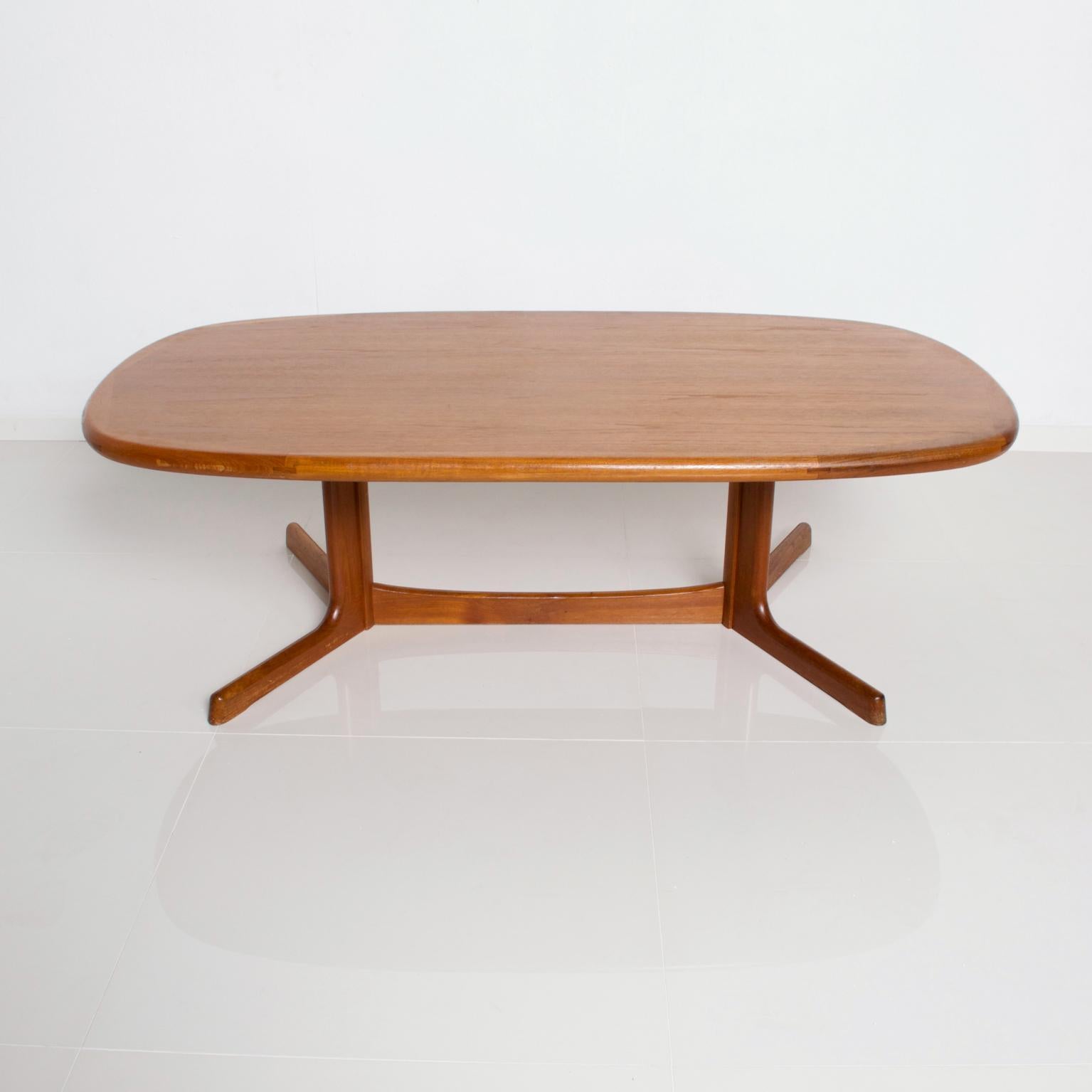 We are pleased to offer for your consideration a coffee table in teak made in Denmark by Dyrlund. Sculptural shape with solid teak legs. Brass label underneath the table Legs can be removed for sage and easy shipping. Dimensions: 53