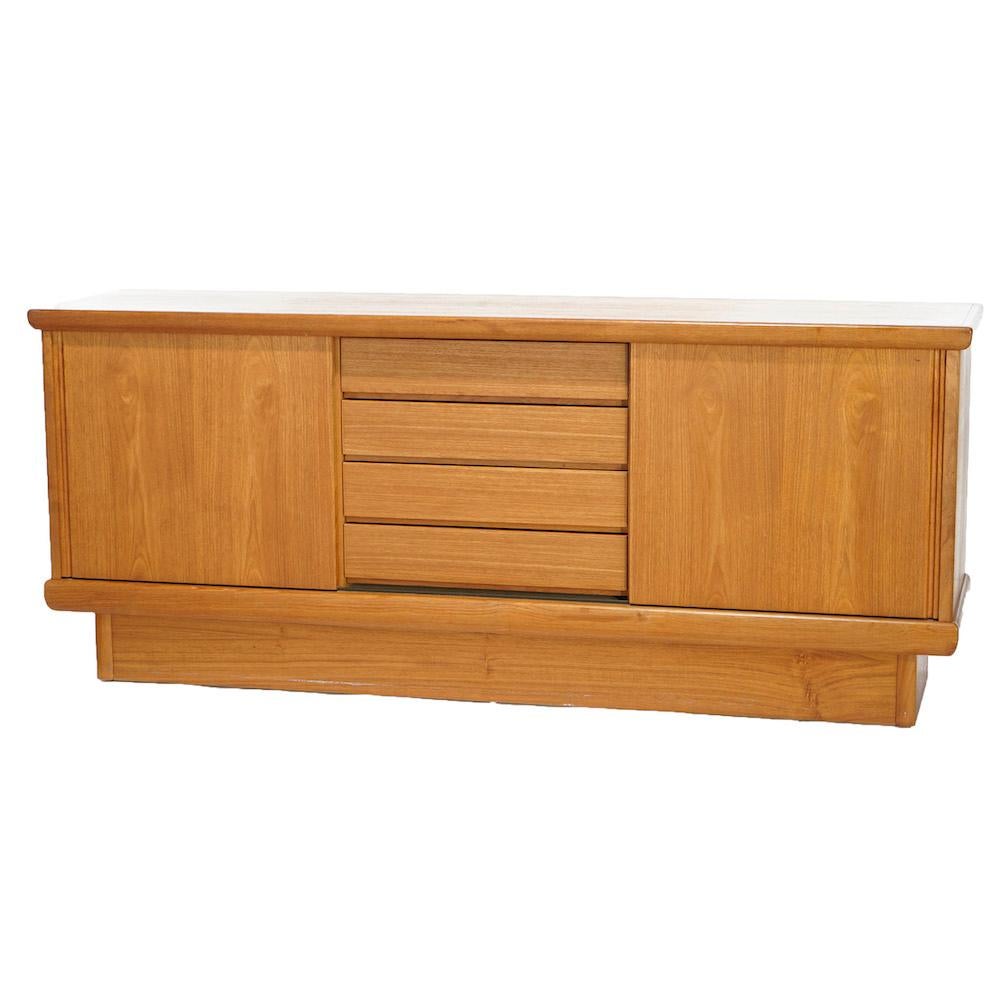 A mid-century Danish Modern credenza by Nordic offers teak wood construction with central drawer tower flanked by sliding door cabinets with shelved interior, maker mark as photographed, 20th century.

Measures- 30.25''H x 72''W x 18''D.

Catalogue