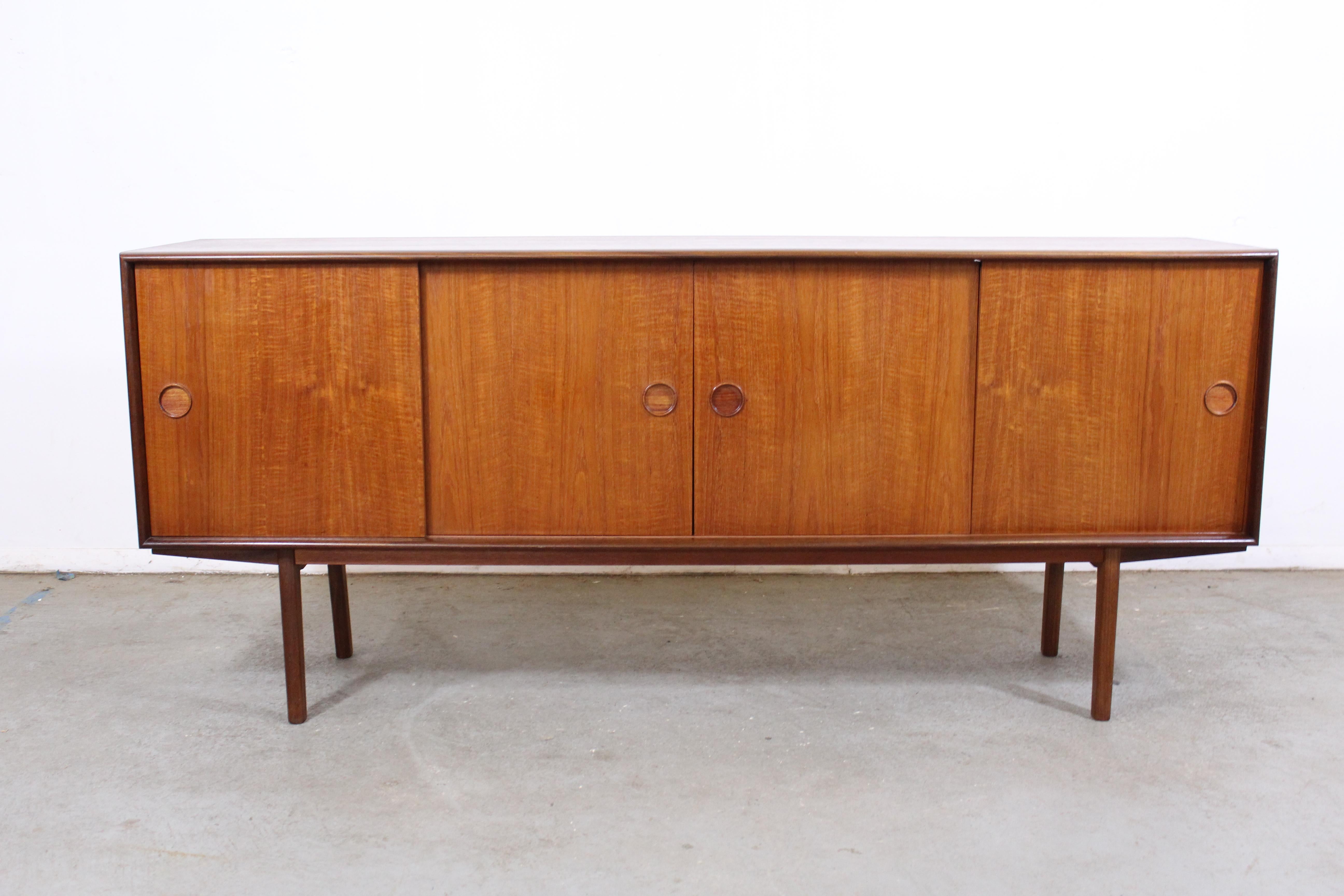Mid-Century Danish Modern Teak Credenza

Offered is a teak credenza. Features 4 sliding doors with shelving, 1 drawer. Contains green felt on the inside. It is in good condition, showing some age wear, (surface scratches/chips, stain on top, fray