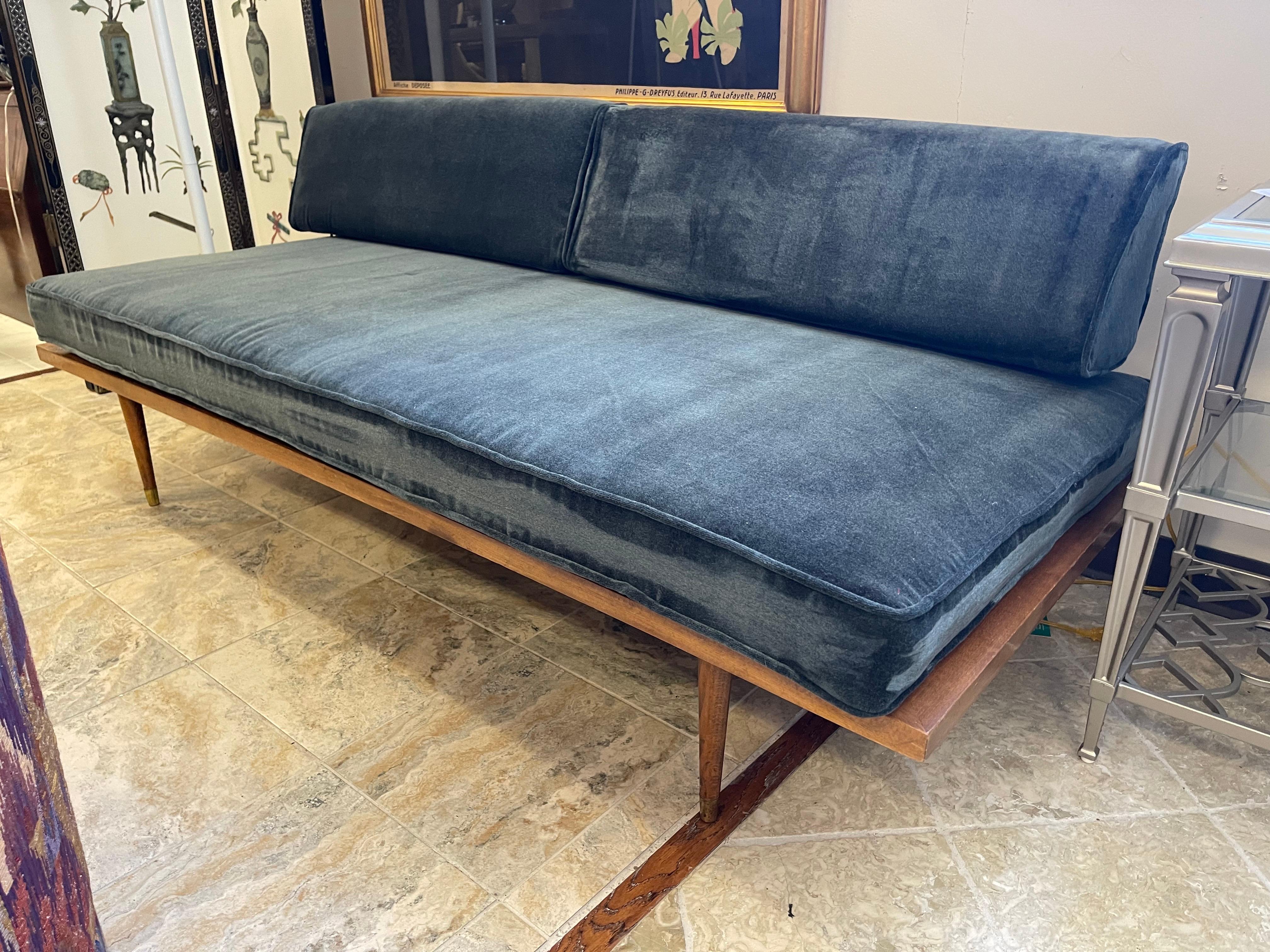 This stunning mid-century modern sofa settee is a true Danish gem. Crafted from high-quality teak wood, the settee features a solid pattern with a luxurious velvet fill material. The upholstery fabric is also made of velvet, providing a plush and