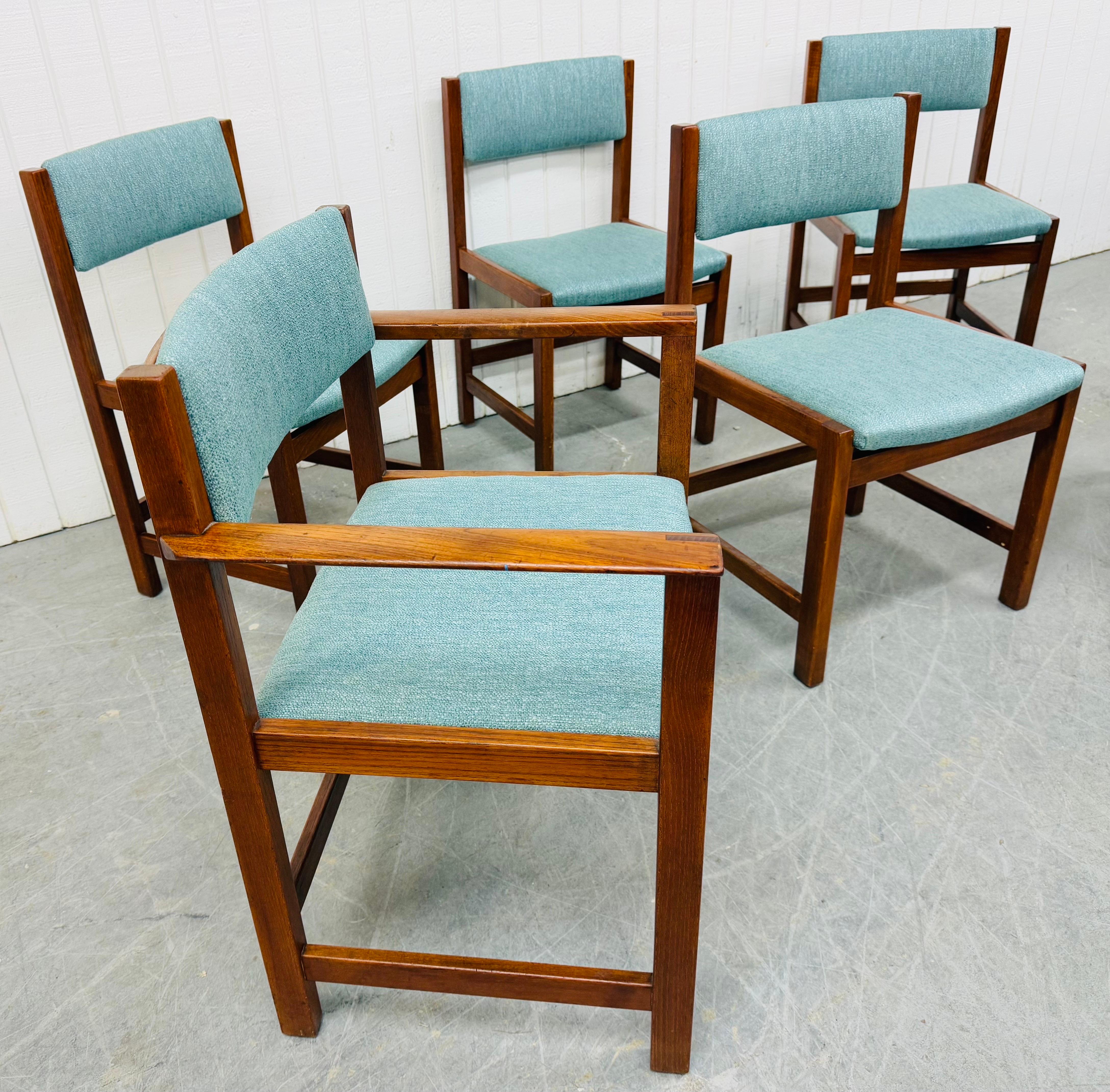 This listing is for a set of six Mid-Century Danish Modern Teak Dining Chairs. Featuring two arm chairs, four side chairs, modern legs with stretcher base, new upholstery, and a beautiful teak finish. This is an exceptional combination of quality