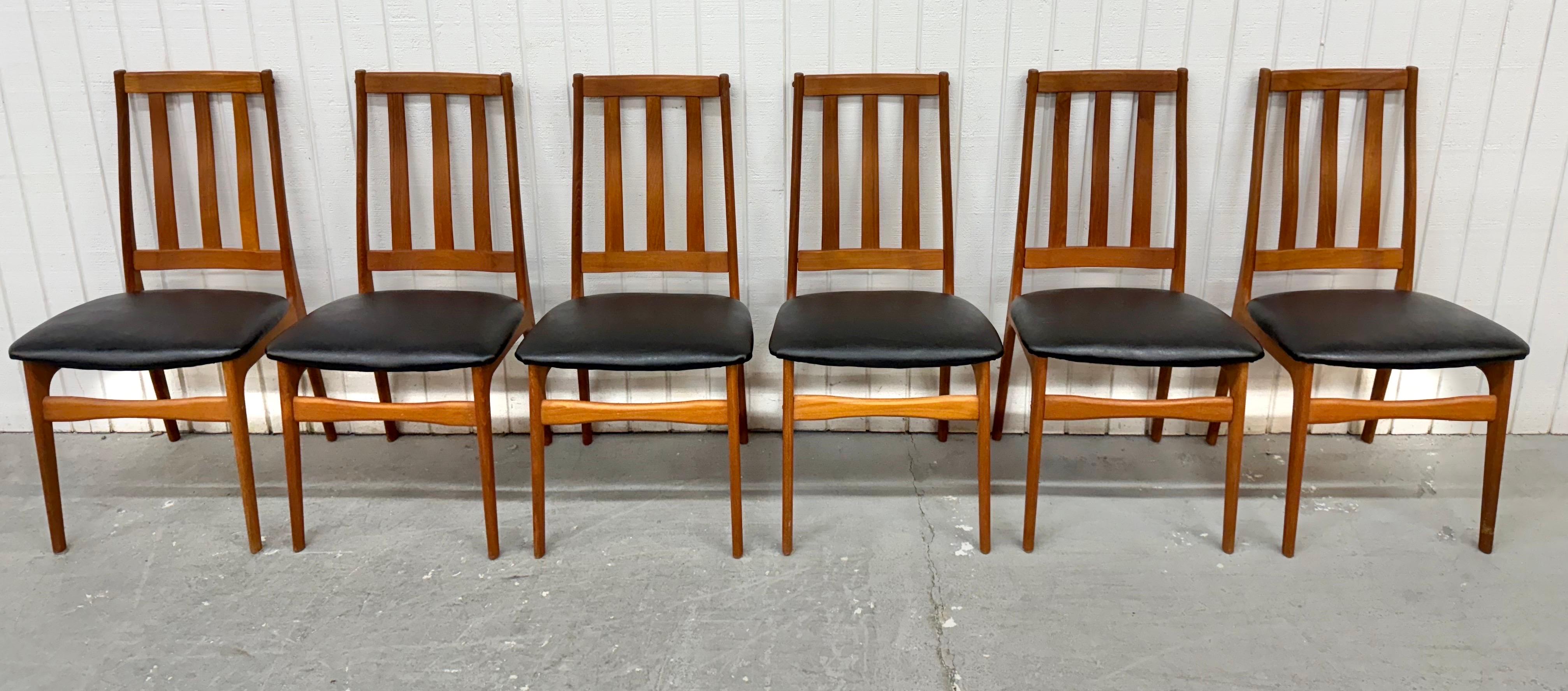 Questa inserzione si riferisce a un set di sei sedie da pranzo in teak moderne danesi del metà del secolo. Caratterizzata da un design con schienale alto e linea retta, struttura in legno di teak e nuove sedute imbottite in vinile nero. Si tratta di