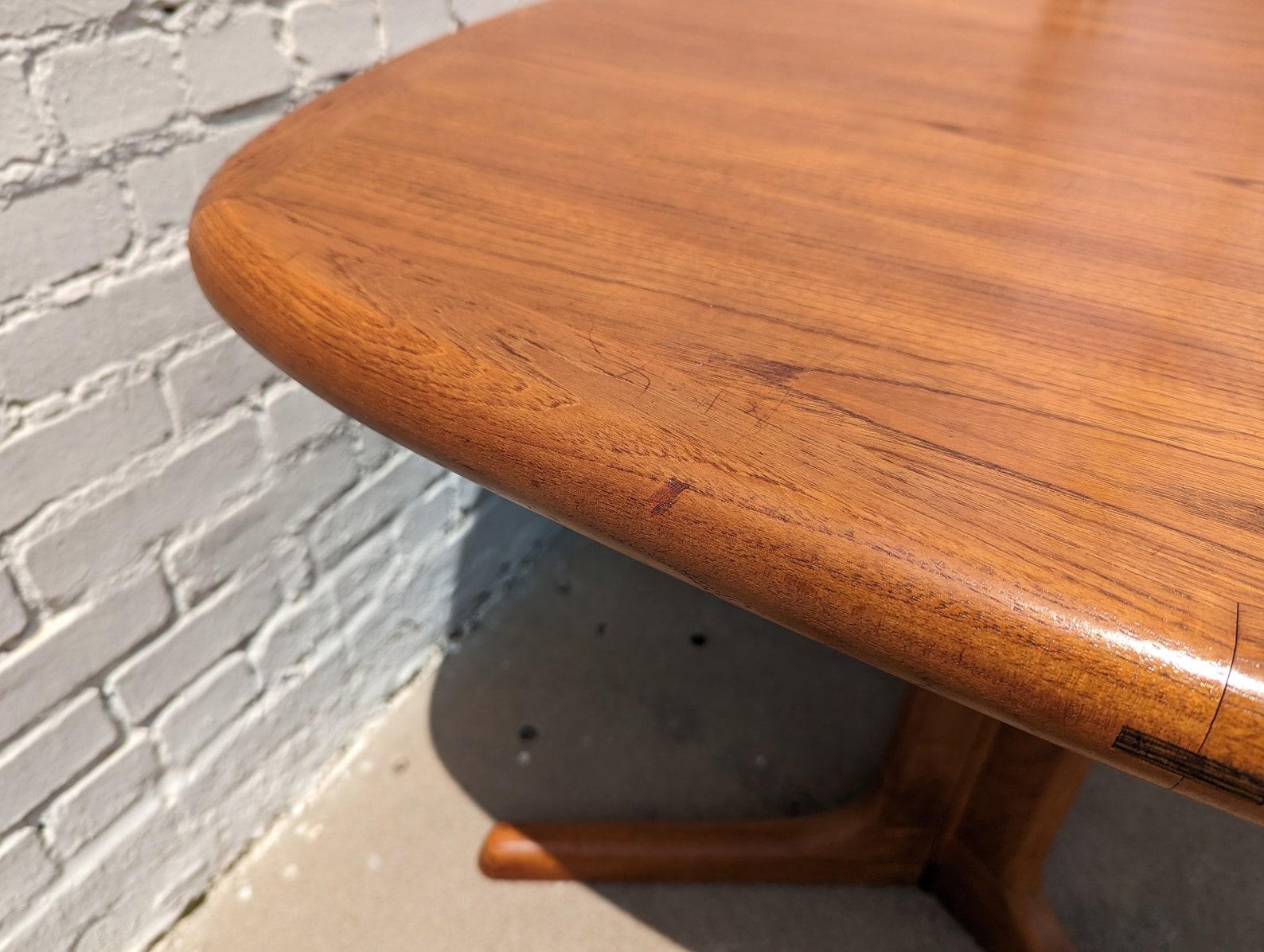 Mid Century Danish Modern Teak Dining Table

Above average vintage condition and structurally sound. Has some expected slight finish wear and scratching. Has a couple small dings and discolorations on top. Has two extension leaves. Outdoor listing