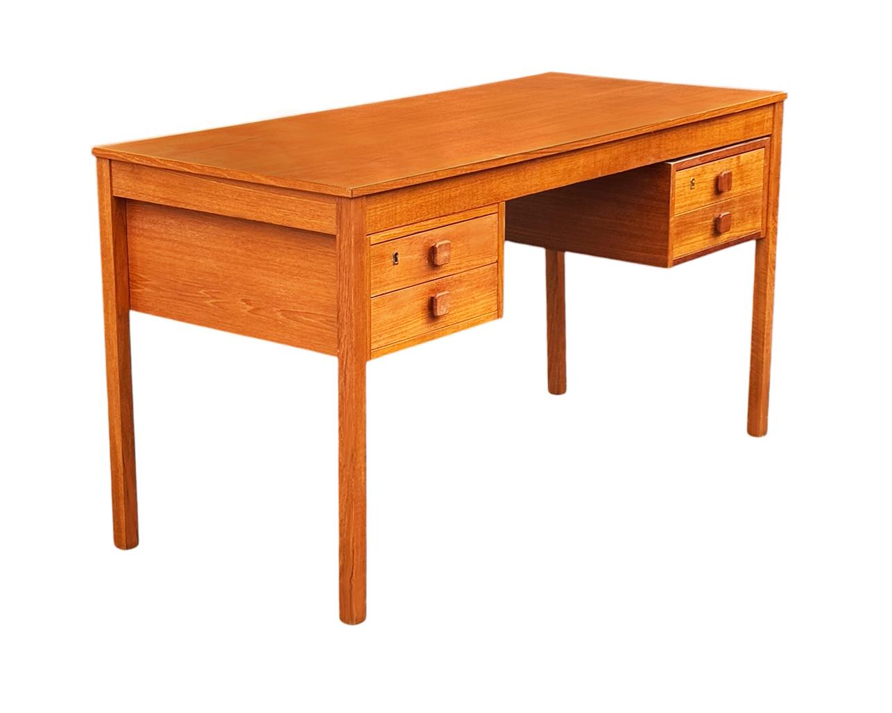 A wonderful and simply designed teak desk from Scandinavia circa 1970's. It features teak construction with finished back. Clean & ready to use condition. No drawer keys present but drawers are unlocked.