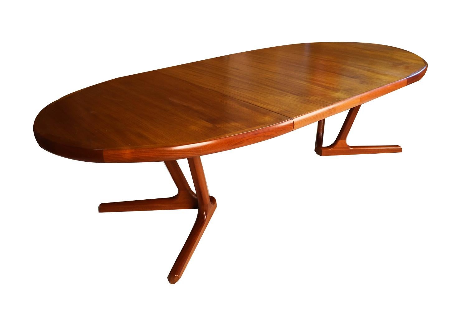 Beautiful Mid-Century Modern expandable oval dining table, manufactured by Interform collection, circa 1970s. Featuring richly grained, gleaming teak and smooth, clean lines characteristic of Classic Danish design. Makers label (Interform collection