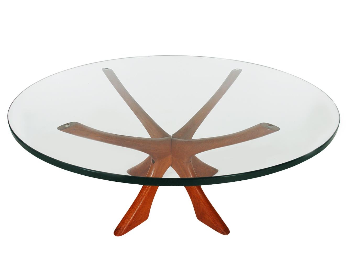 A Scandinavian Classic designed by Illum Wikkelsø and manufactured by CFC Silkeborg in Denmark, circa 1960s. The table features a solid teak constructed base with a super thick clear glass top.