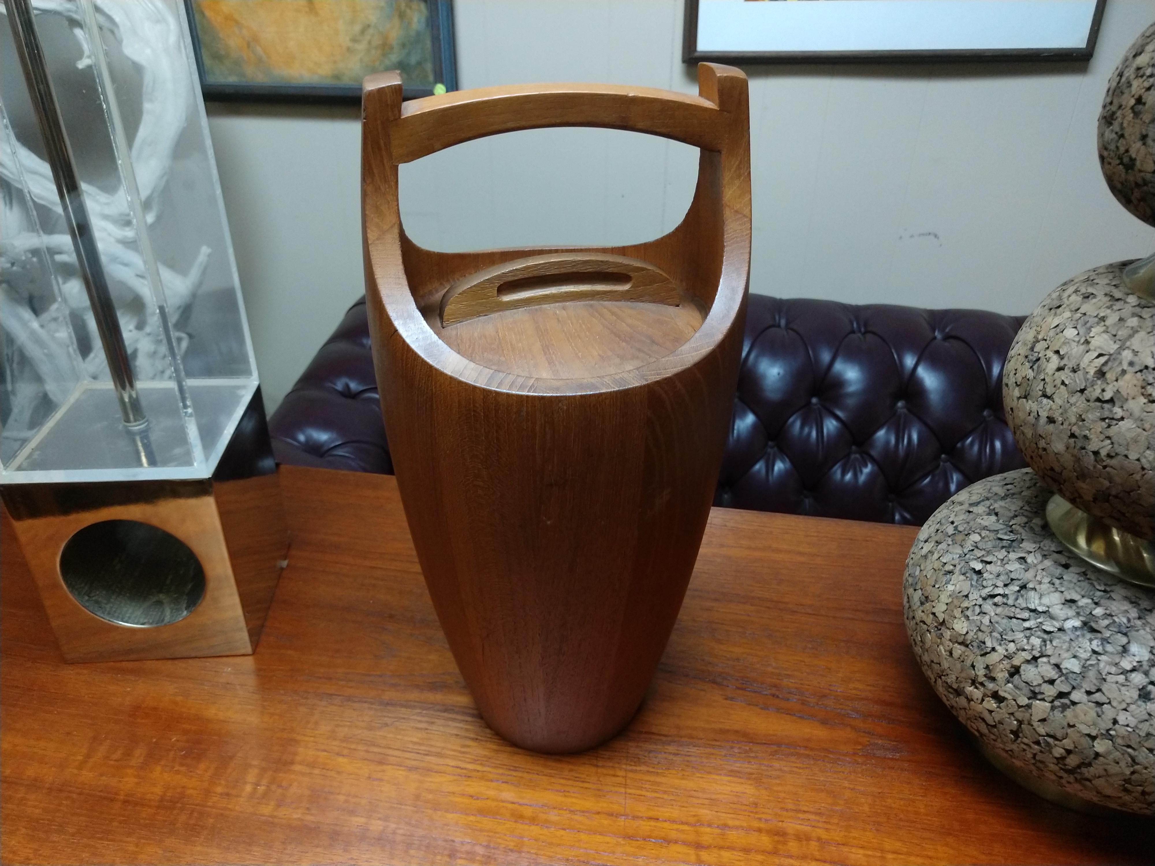 Sculpted teak ice bucket with plastic liner by Jens Quistgaard. Signed on underside.