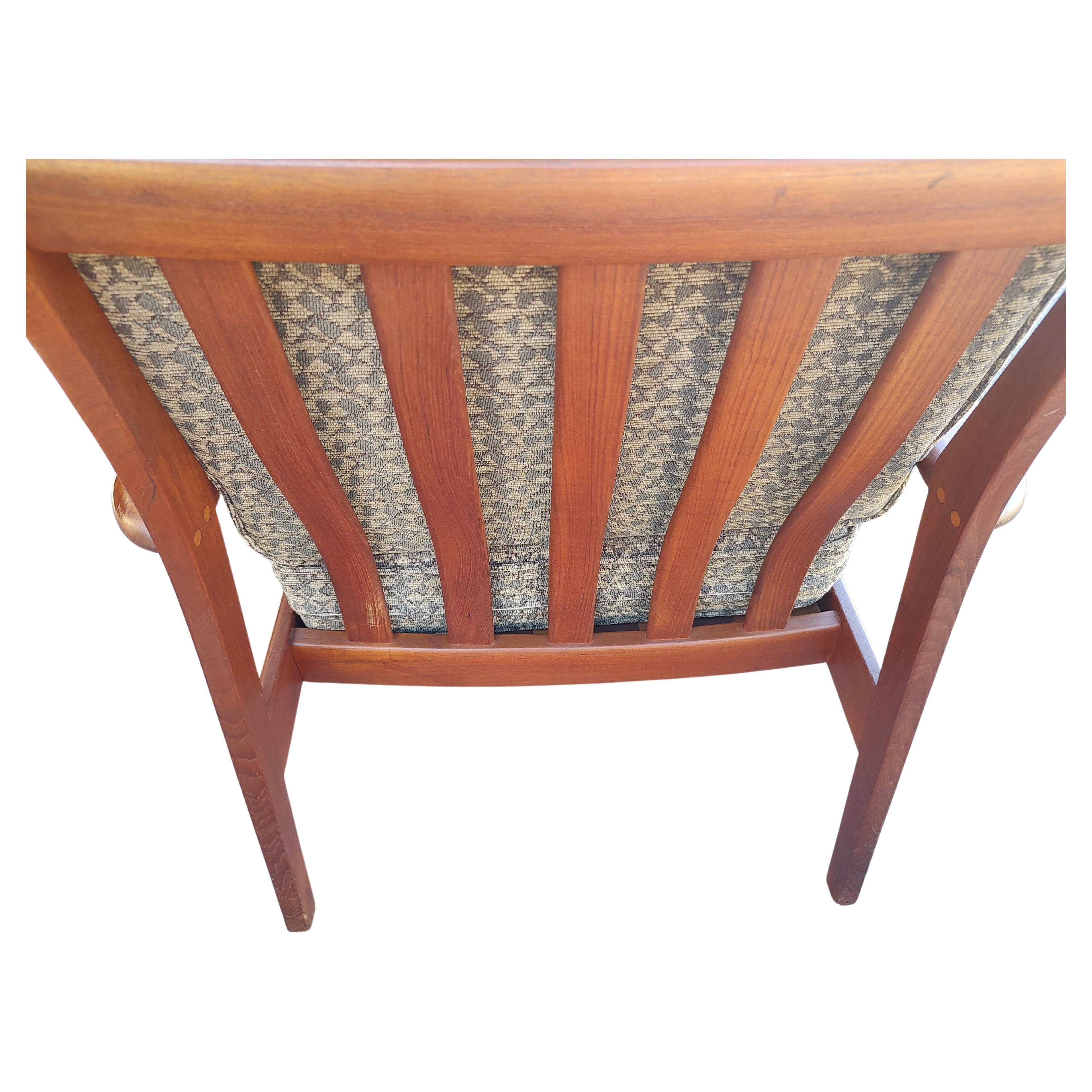 Simple and elegant Danish teak lounge chair with updated cushions. Checkered pattern in a greenish gray in very good condition. Curved with wide slatted back. In excellent vintage condition with minimal wear. See pics. 